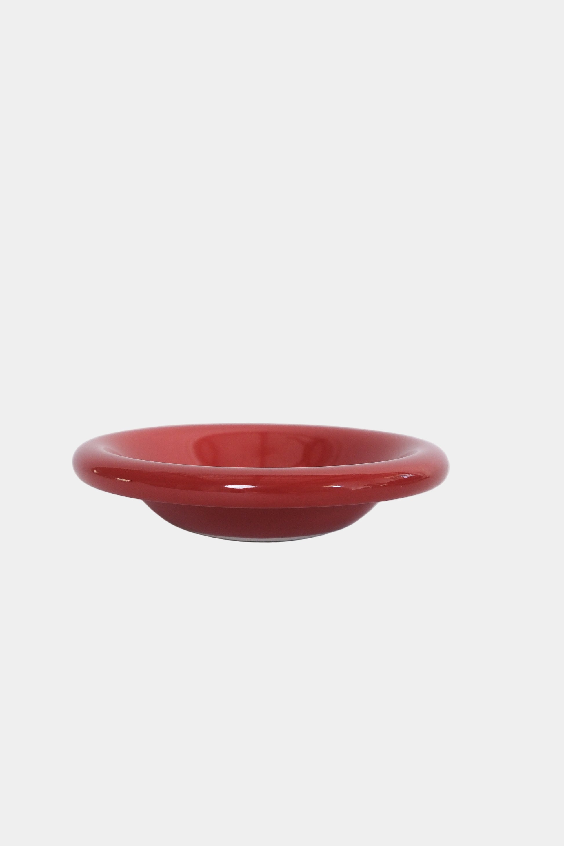 side bowl in tomato on white background, side view