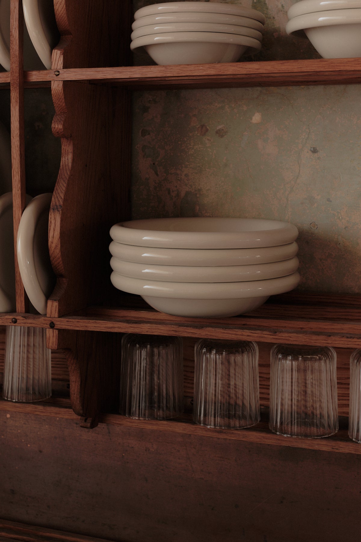 stack of marshmallow serving bowls on wooden shelves