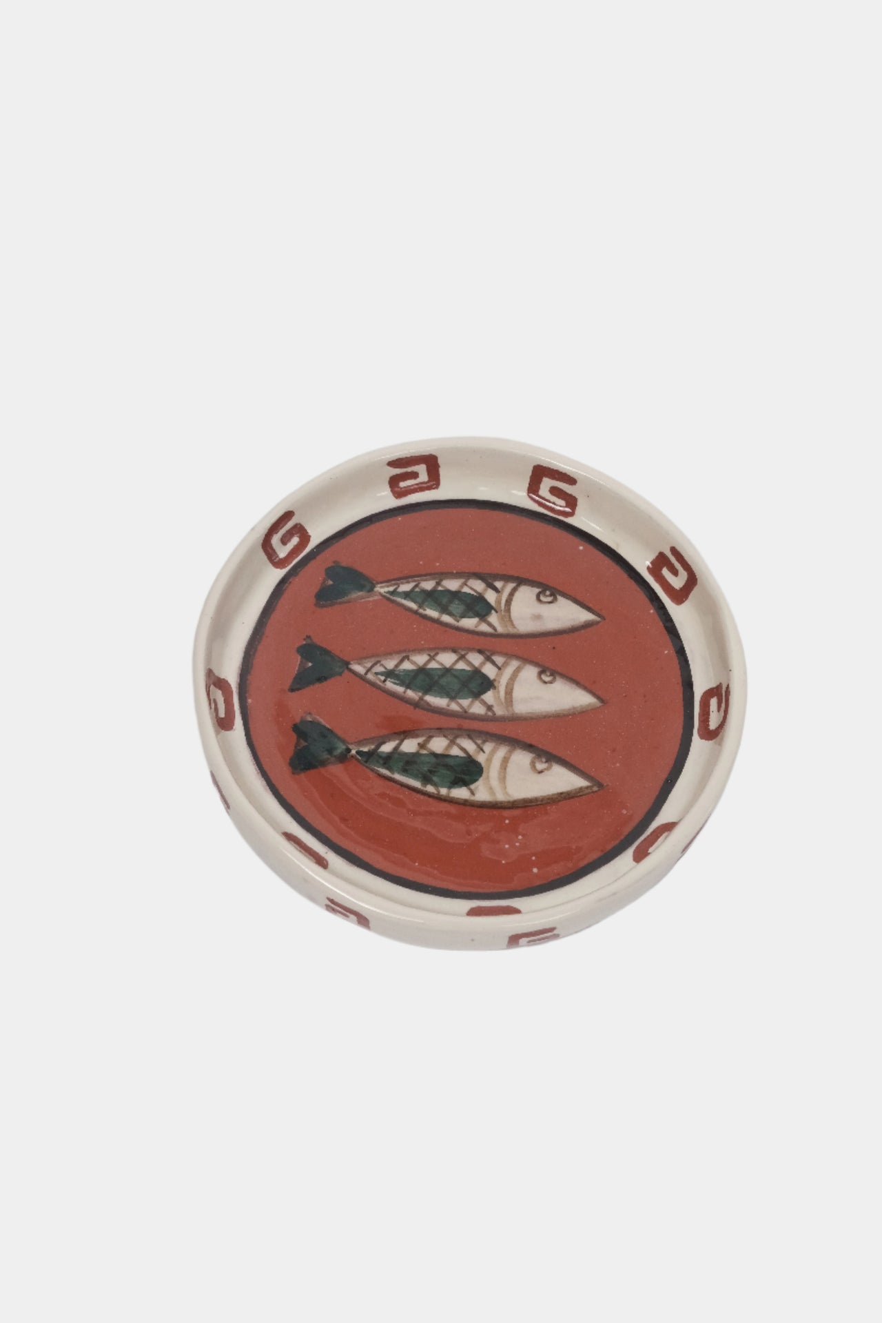 terracotta plate, illustrated with three fish. Top view