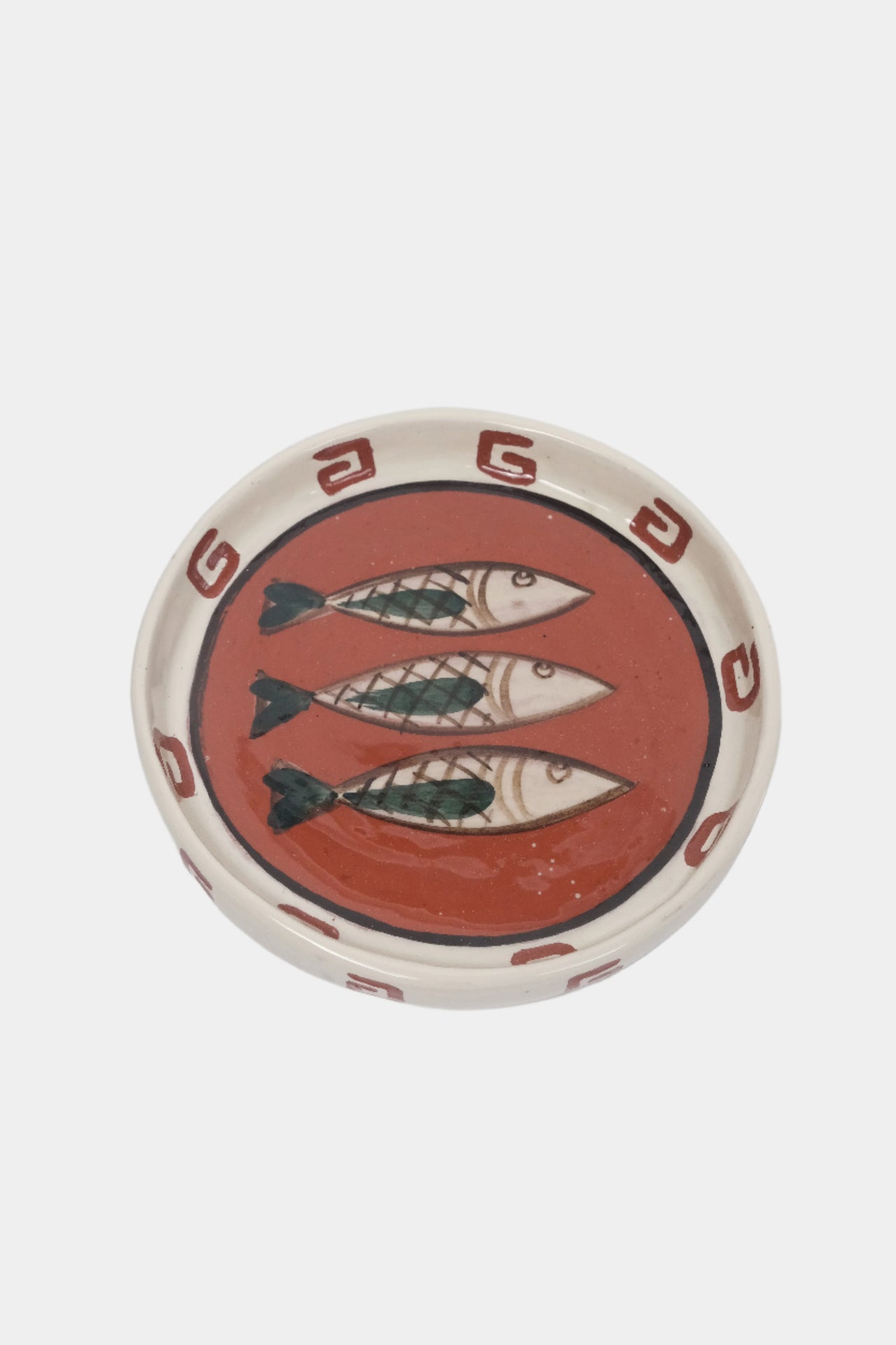 terracotta plate, illustrated with three fish. Top view