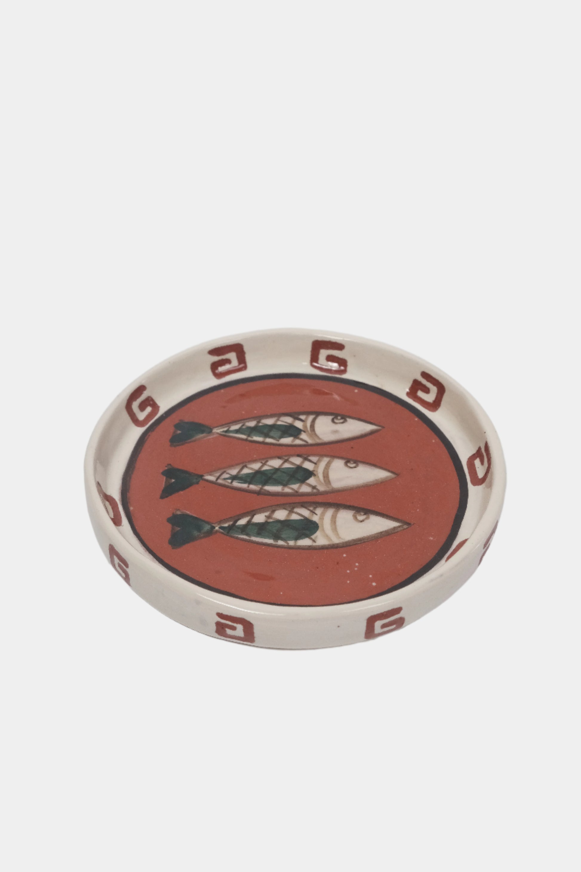 Terracotta plate with hand illustrated fish design