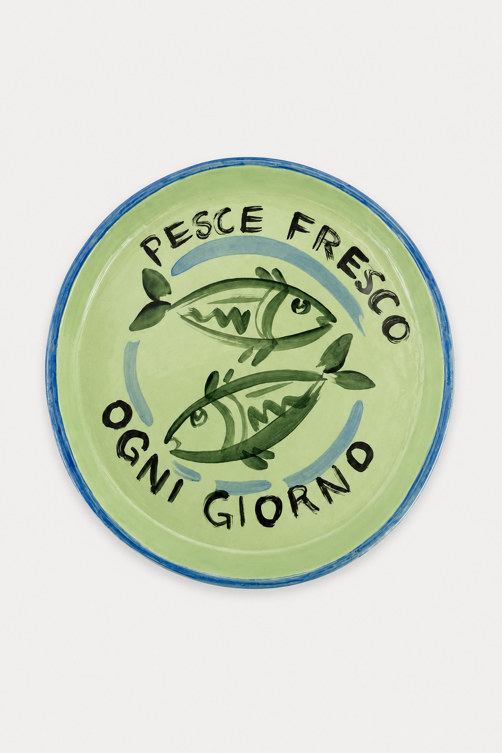 Di Lunedi sardine plate with a light green background, featuring two green fish illustrations, a blue rim, and the Italian text 'PESCE FRESCO OGNI GIORNO' in black. The plate is photographed flat against a neutral background -East Coast General. 