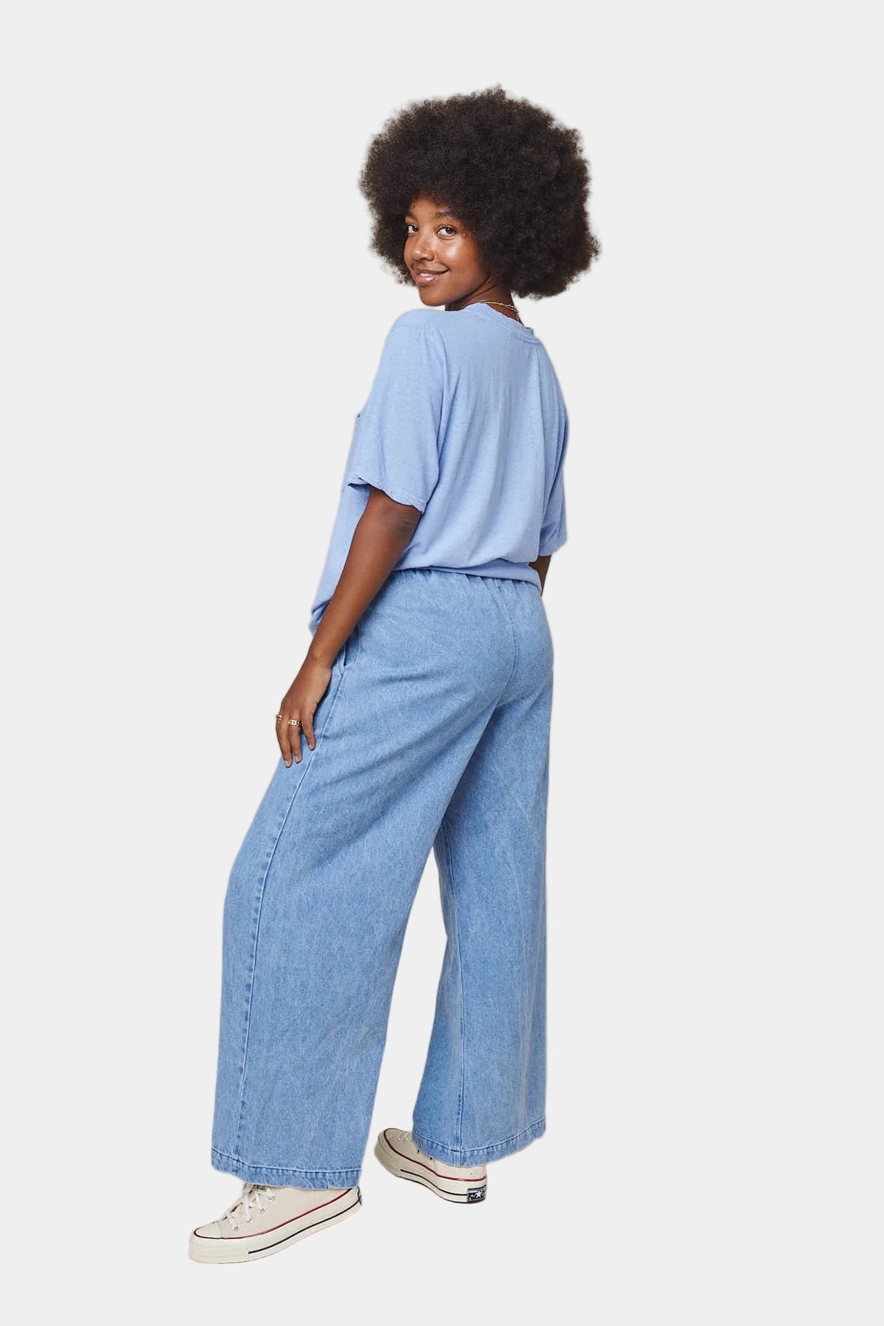 Light blue denim pants on a white background