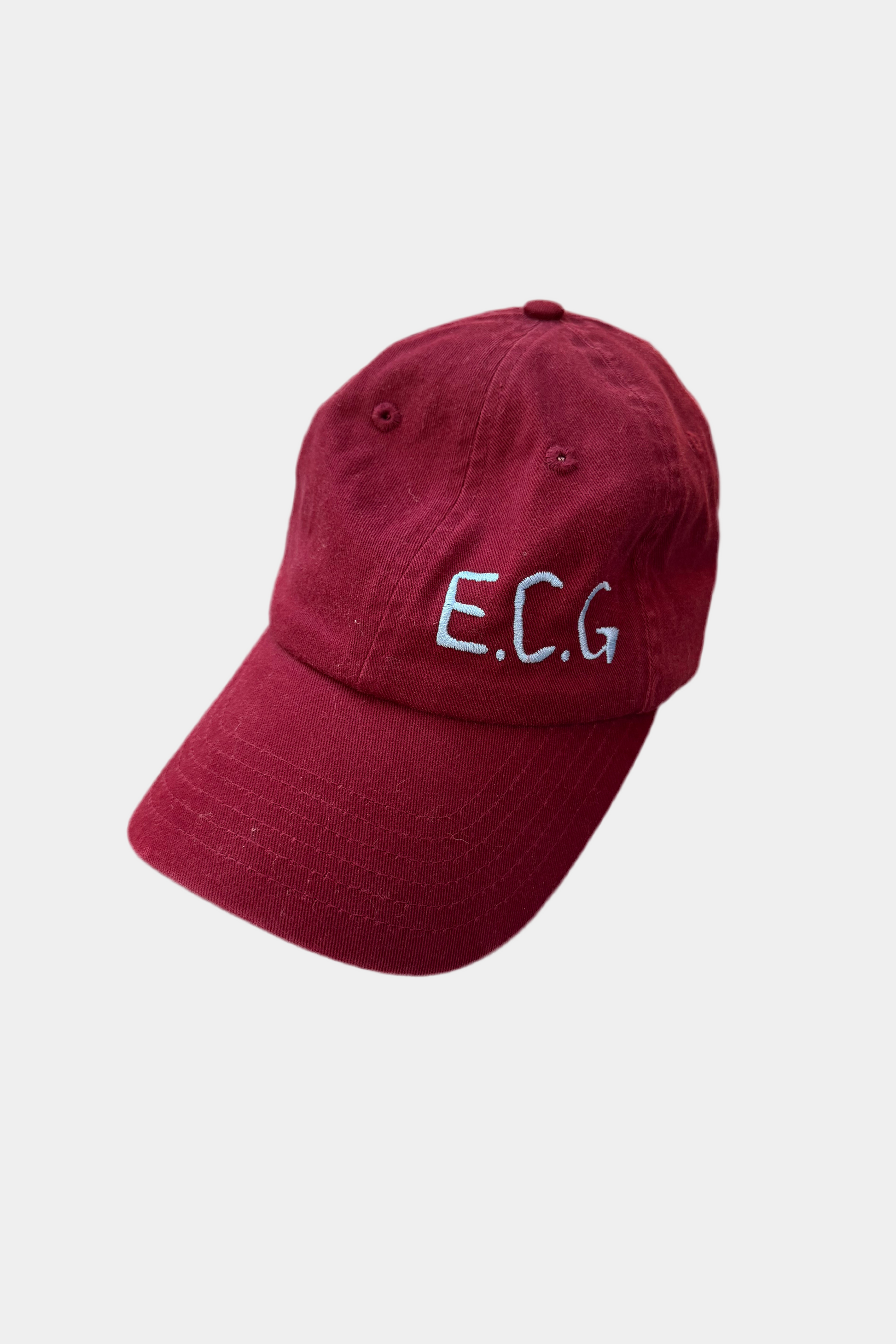 Burgundy cap with 'E.C.G.' text on a light gray background