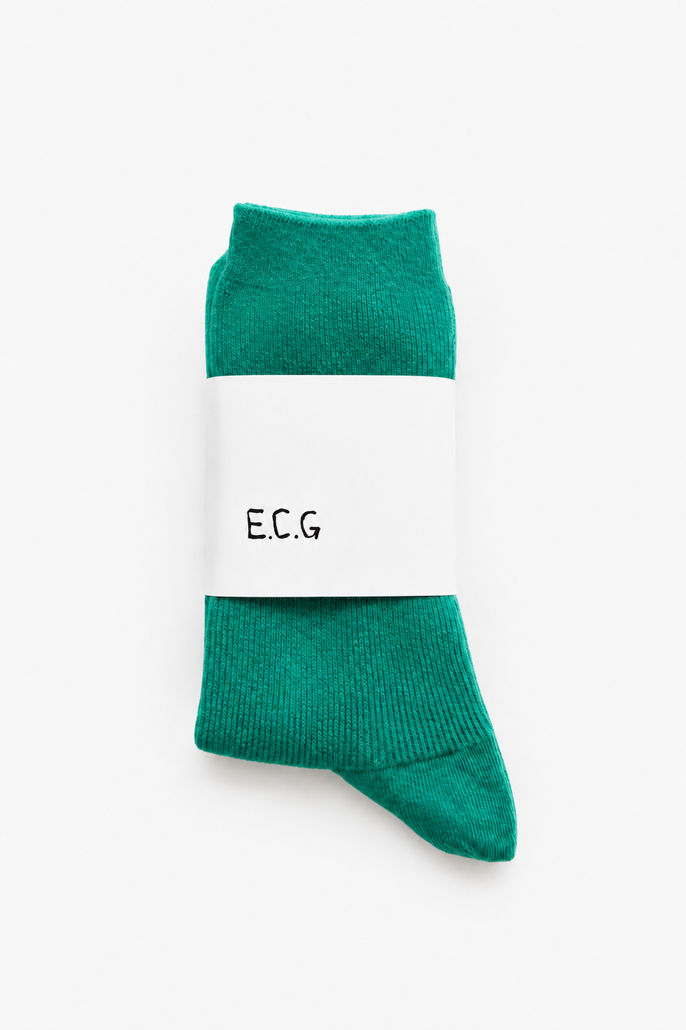 A pair of emerald green cotton ribbed crew socks with a white paper band around the middle printed with the brand name E.C.G - East Coast Genera