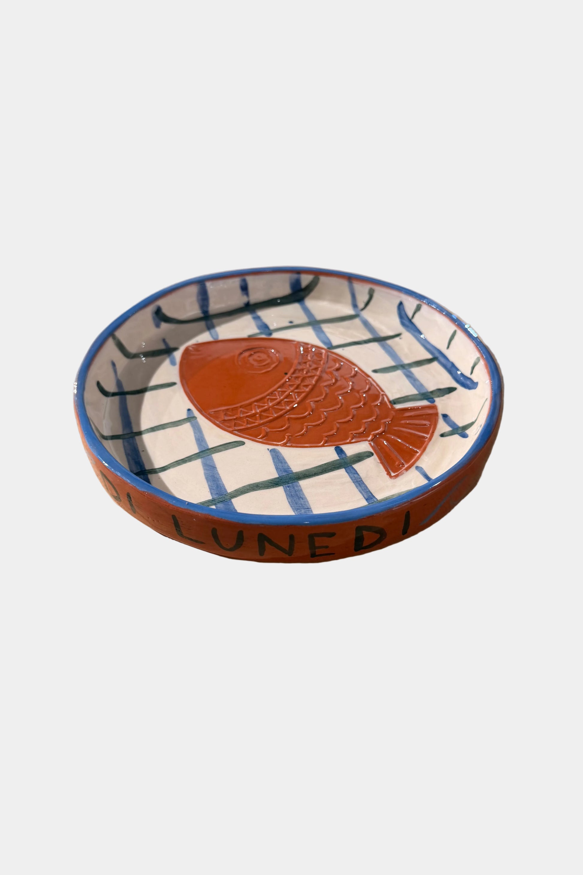 Ceramic plate with fish design on a plain surface