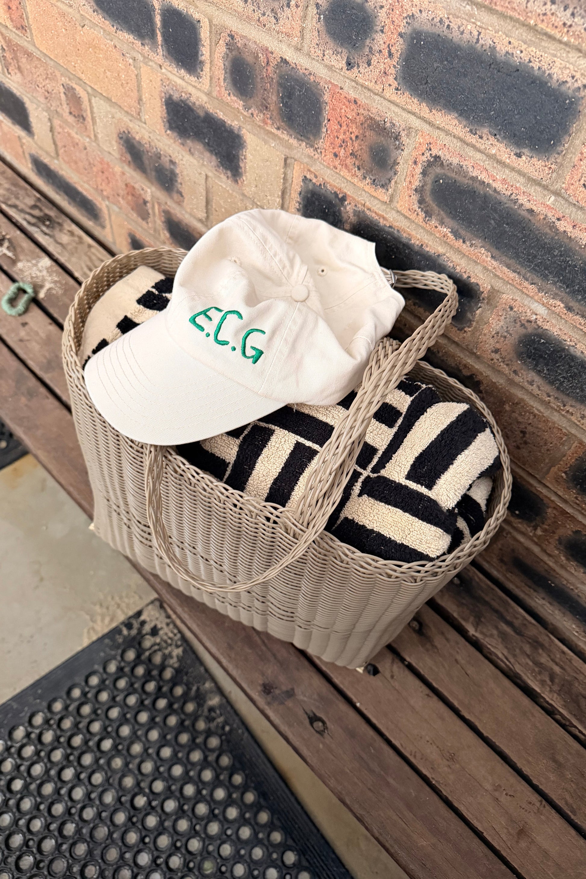 Palorosa Tote bag with a baina tool and a off white ECG baseball cap, sitting on a wooden beach
