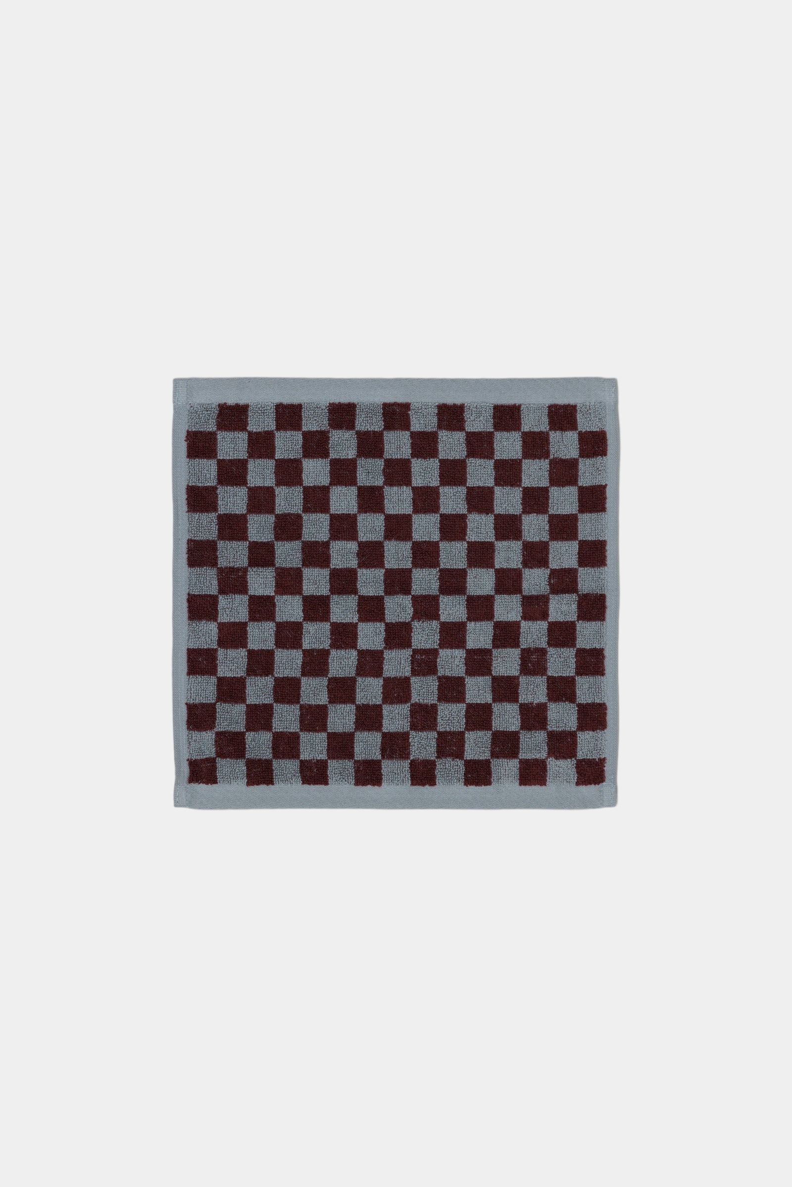 Checkered pattern face cloth  on a plain background