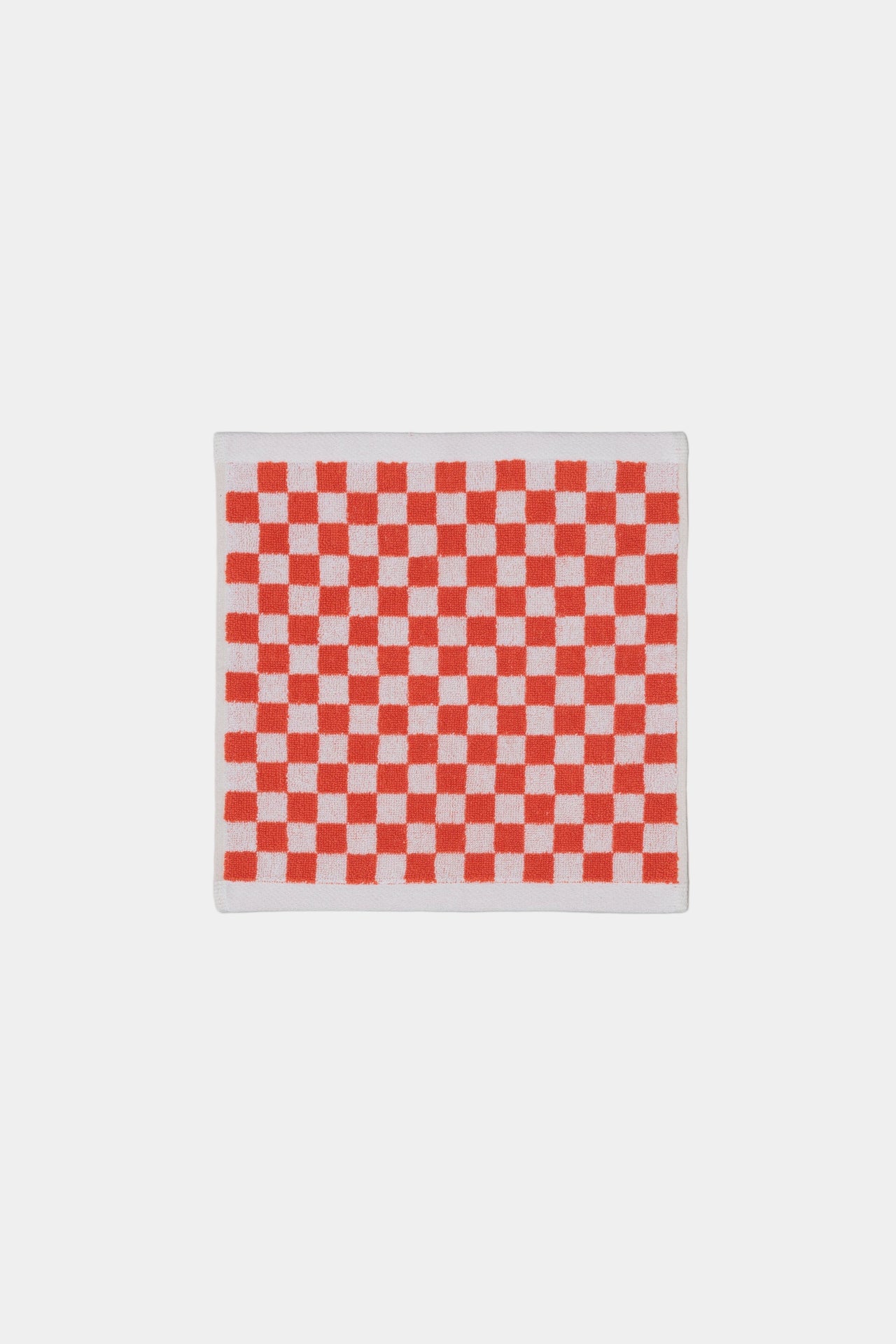 Red and white checkered face cloth on a white  background