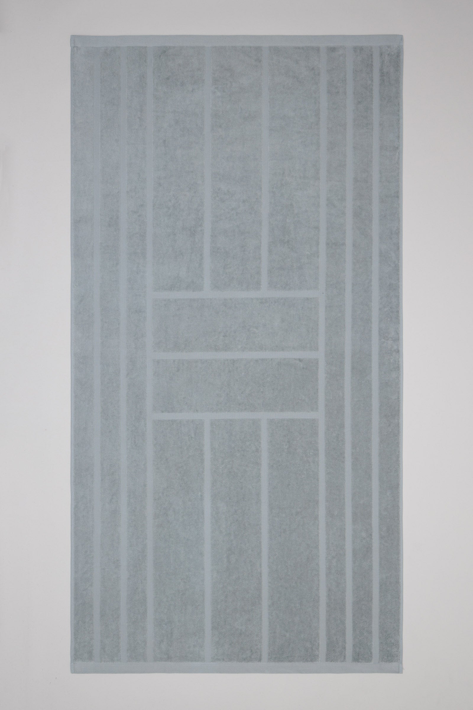 Gray textured pool towel on a plain background