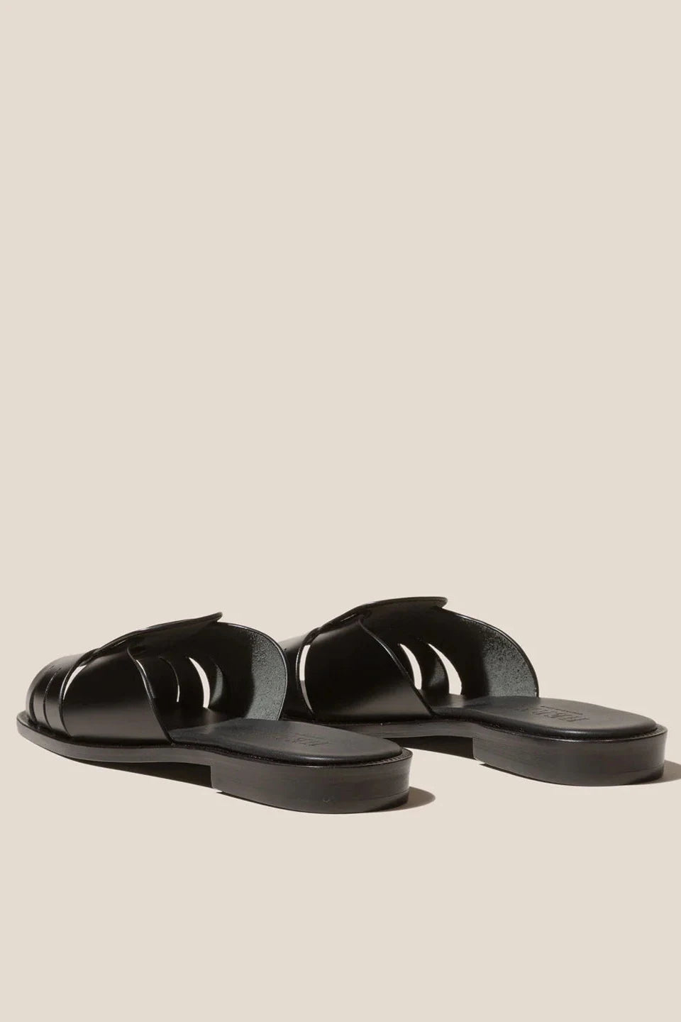 Black sandals on a beige background