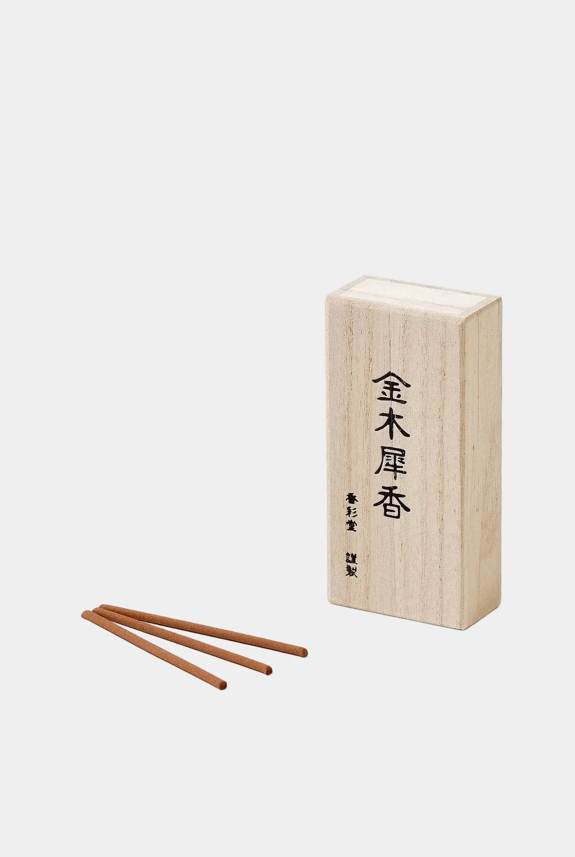 Wooden incense box with two sticks on a white background