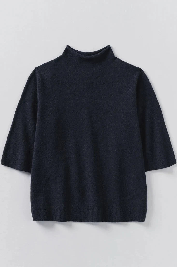 Dark navy turtleneck sweater on a light gray background