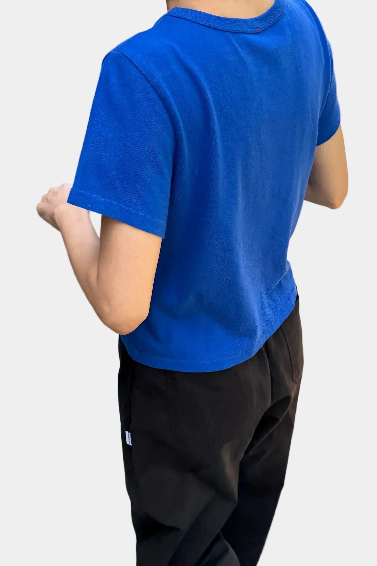 Person wearing a blue t-shirt and black pants 