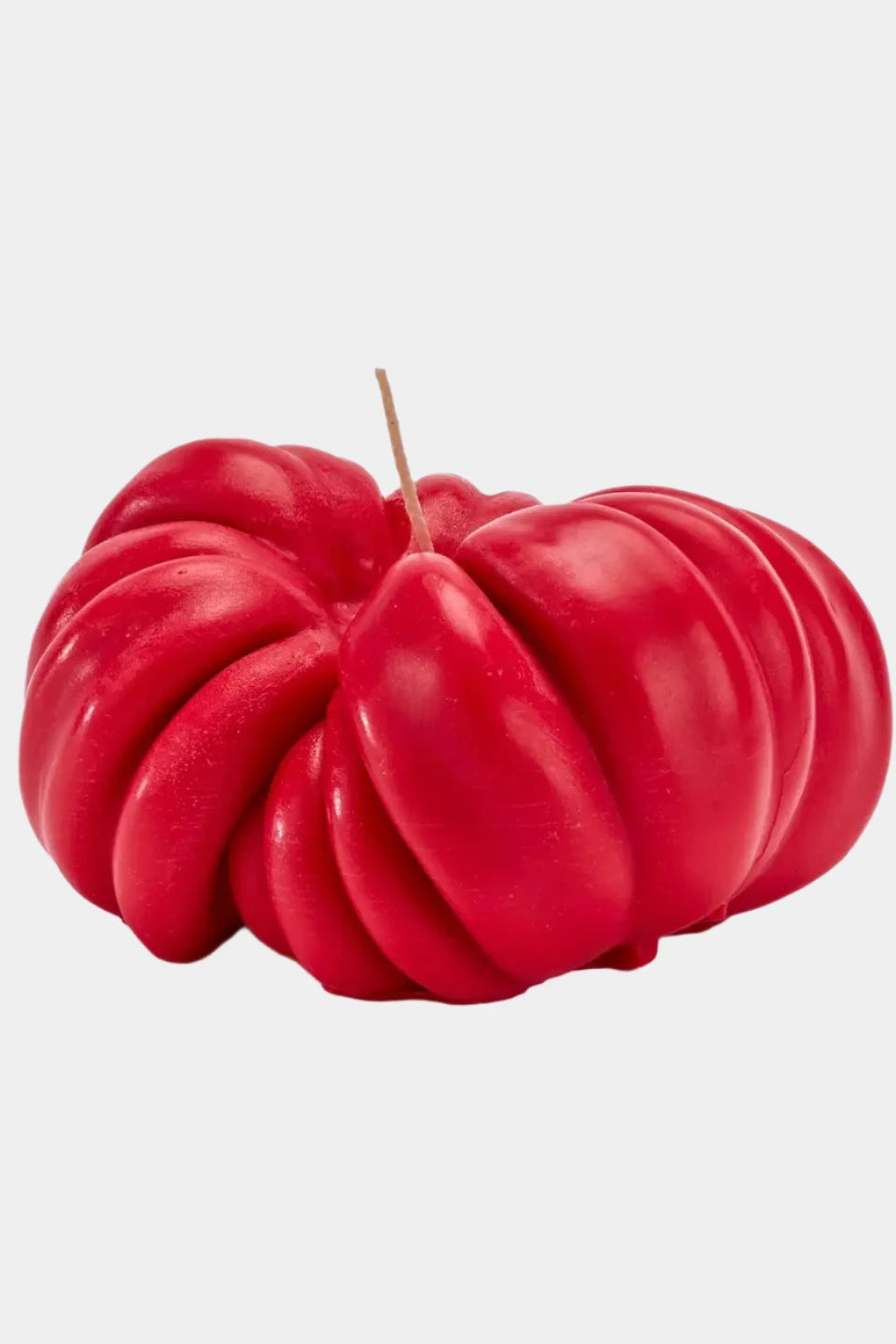 Heirloom red tomato candle on white background 