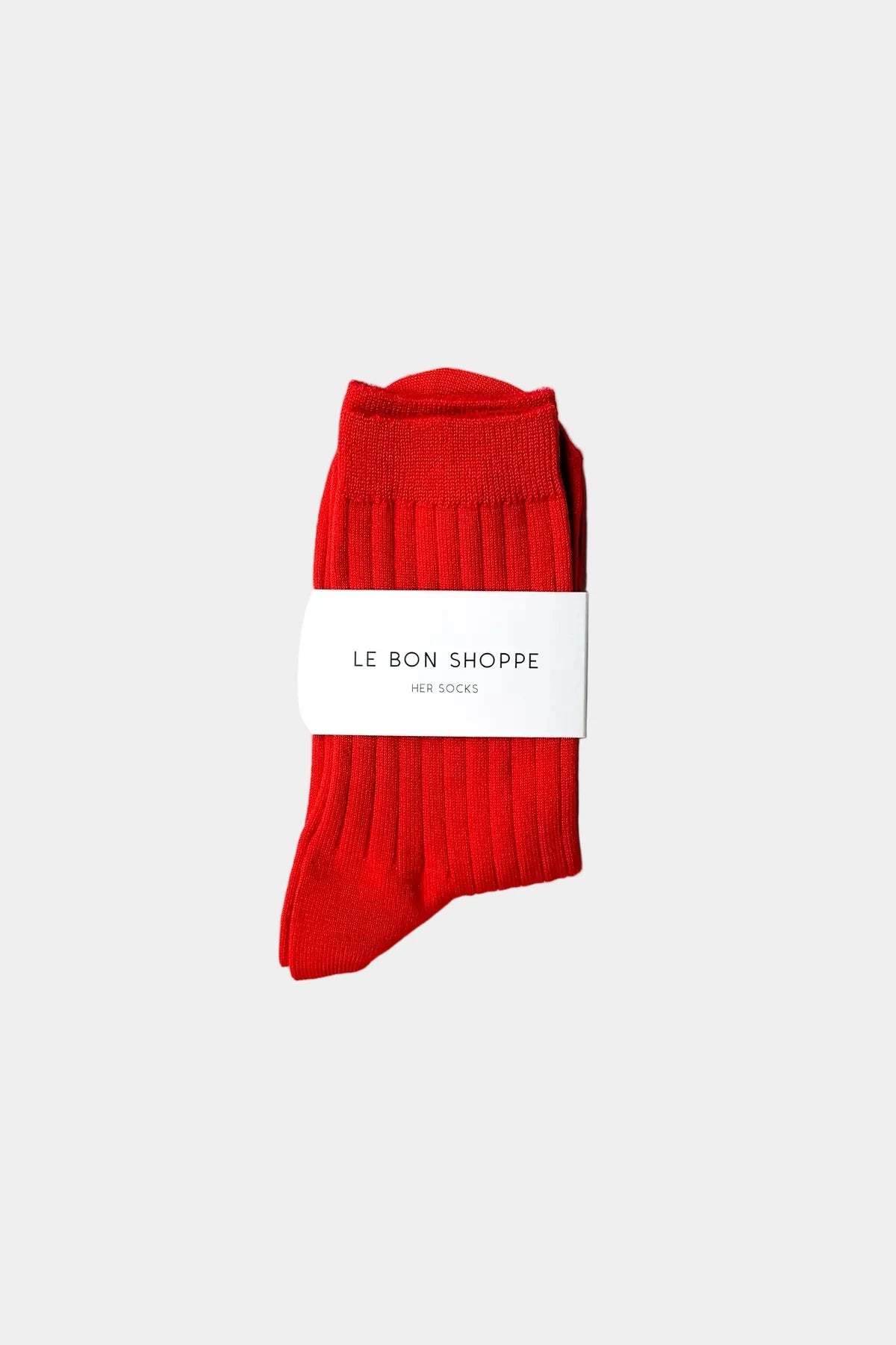 Red socks with a white label on a white background
