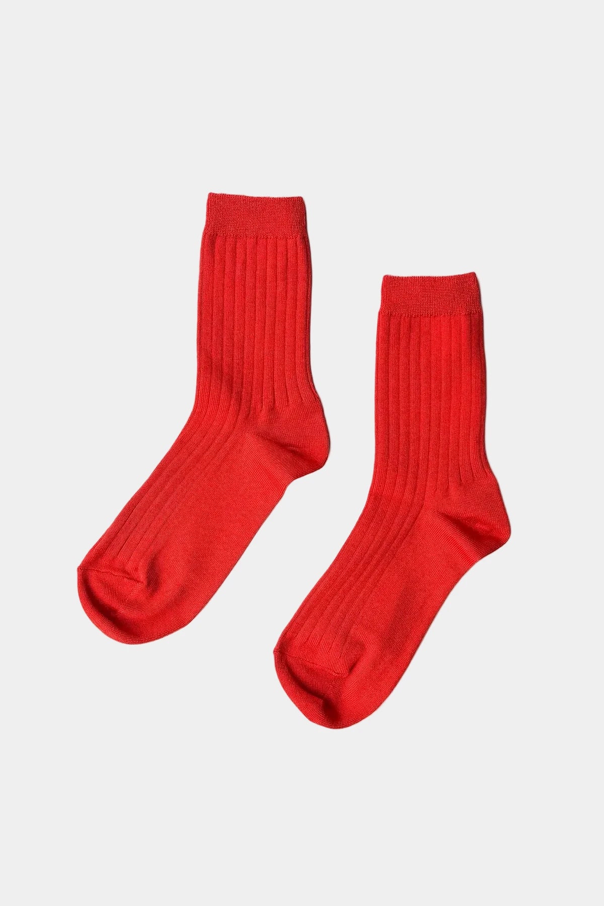 Pair of red socks on a white background