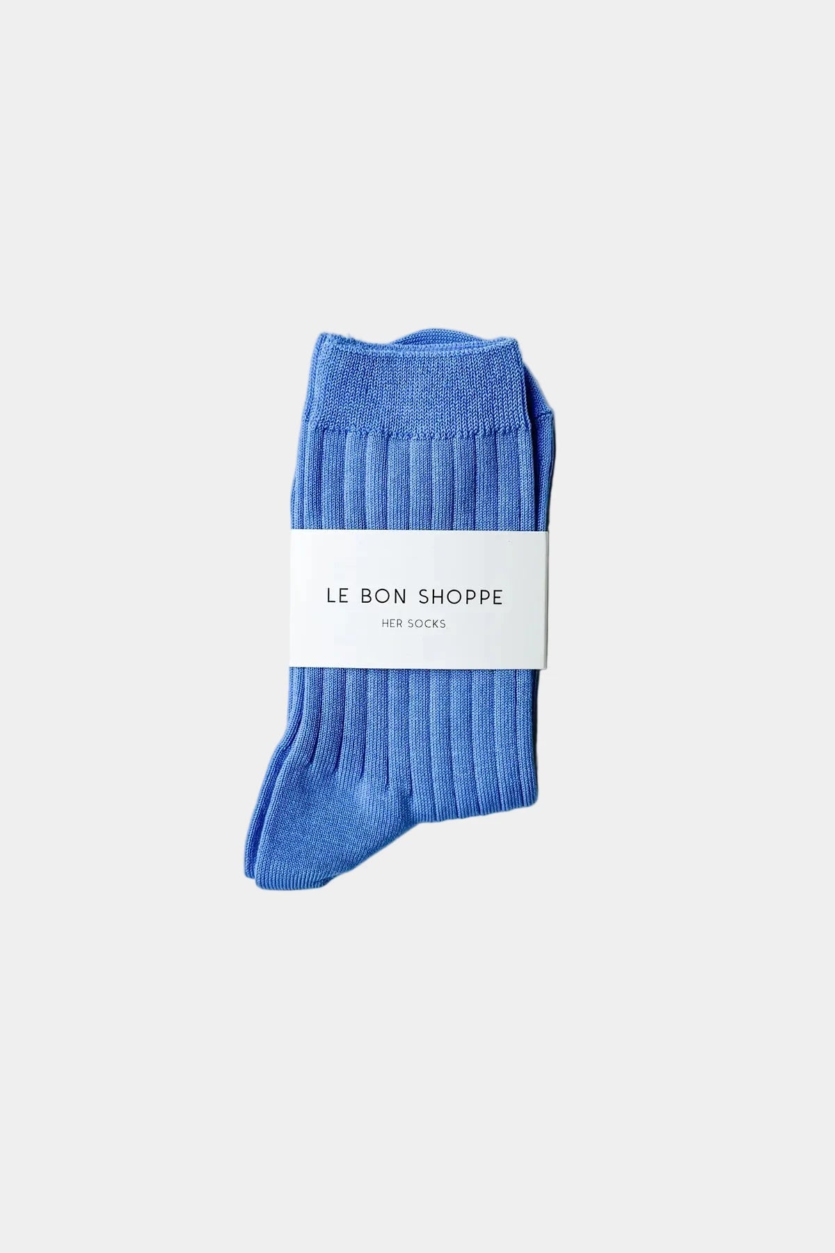 Blue socks with a white label on a light gray background