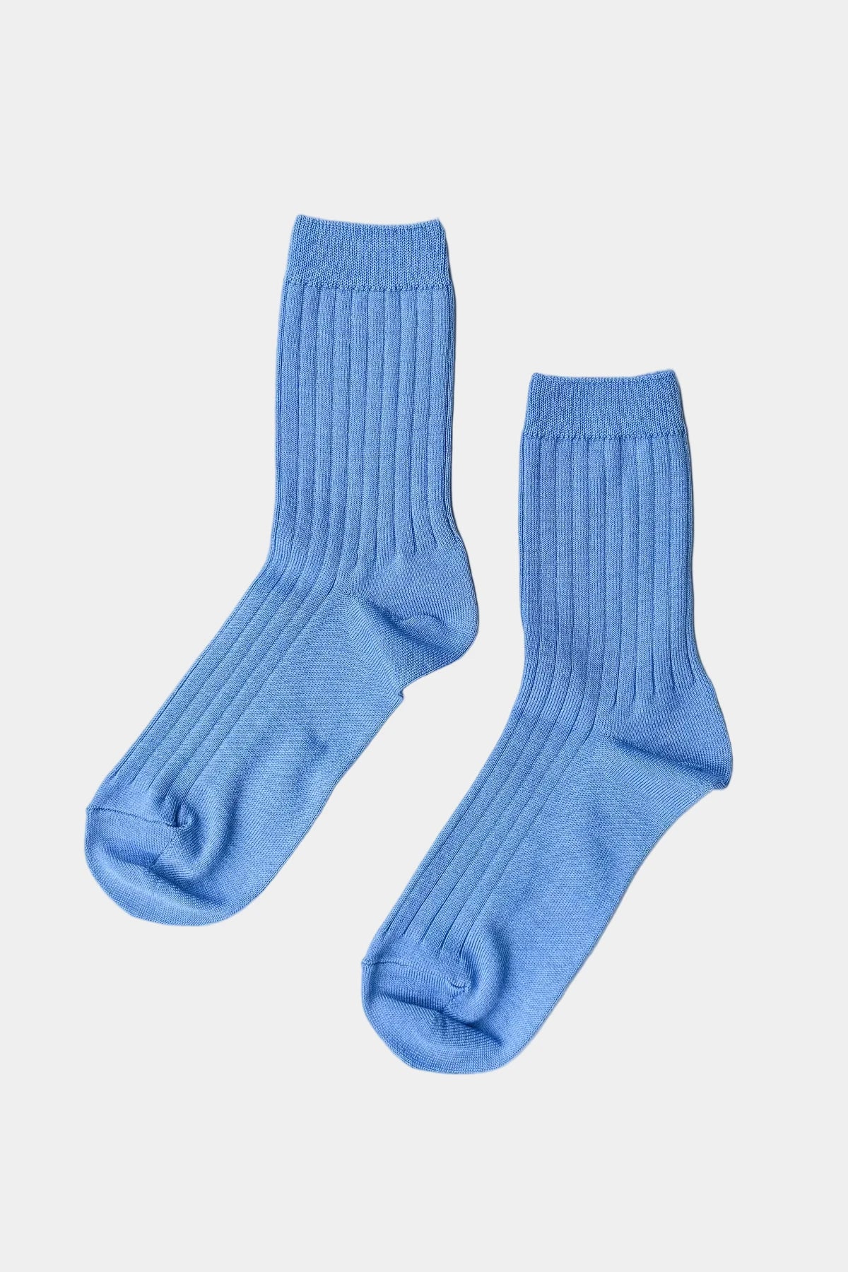 Pair of blue socks on a white background