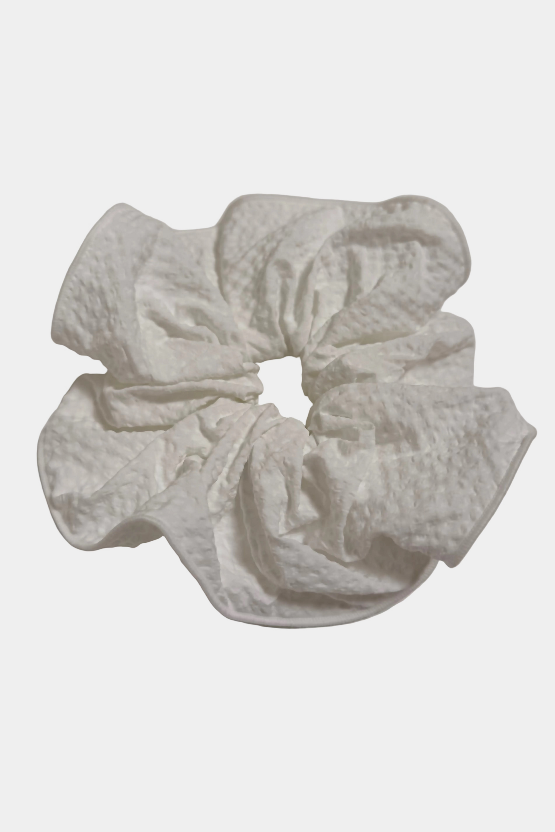 White textured scrunchie on a light gray background
