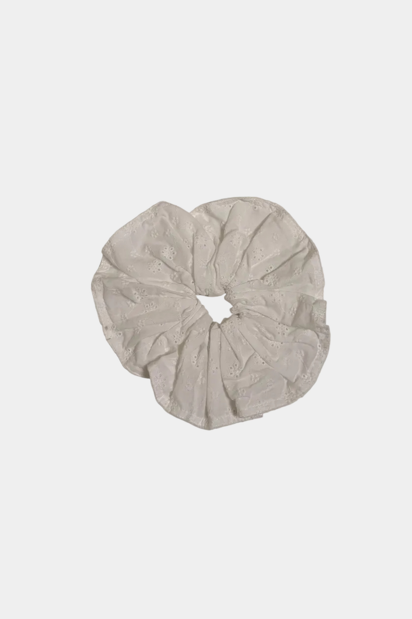 White scrunchie on a light gray background