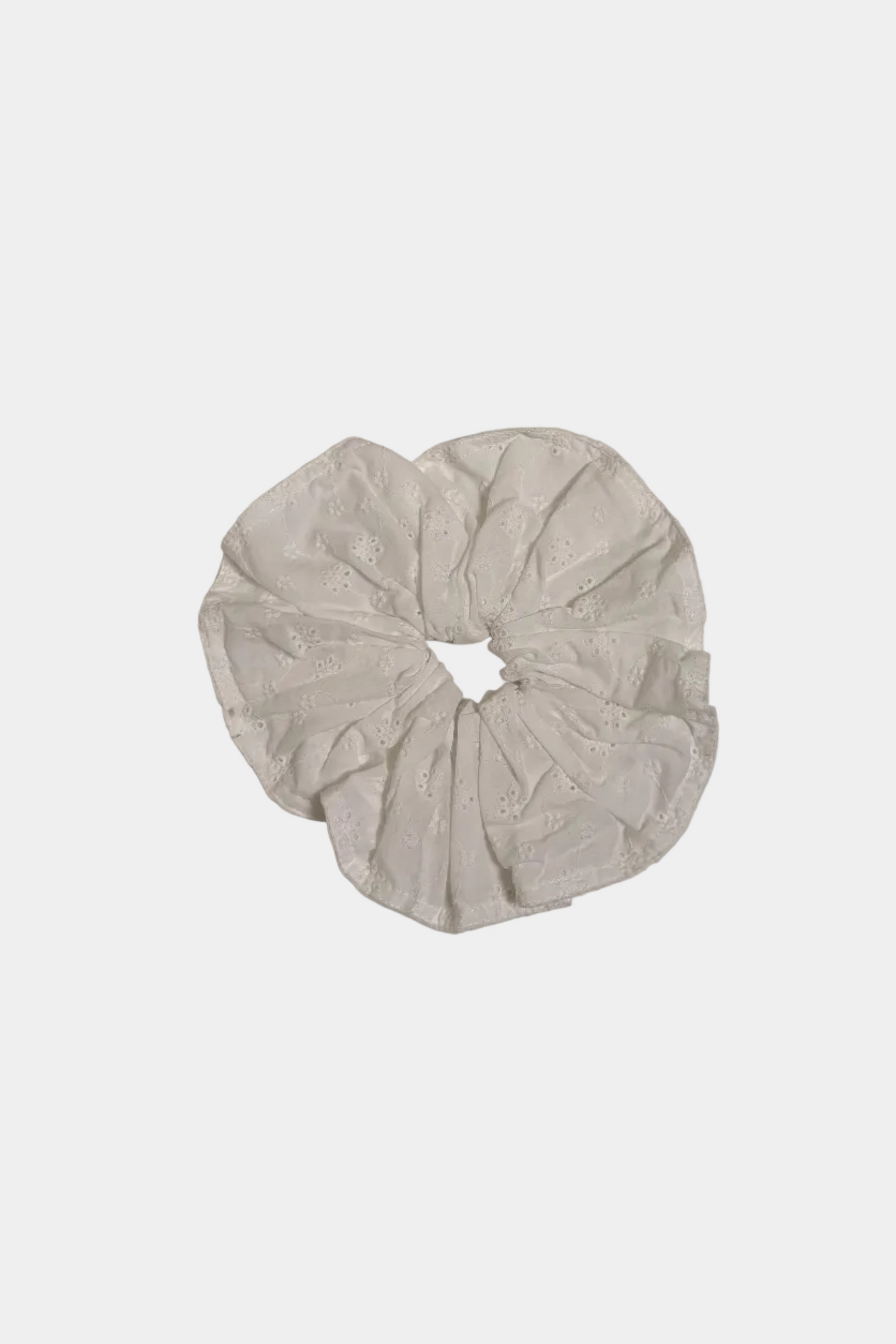 White scrunchie on a light gray background