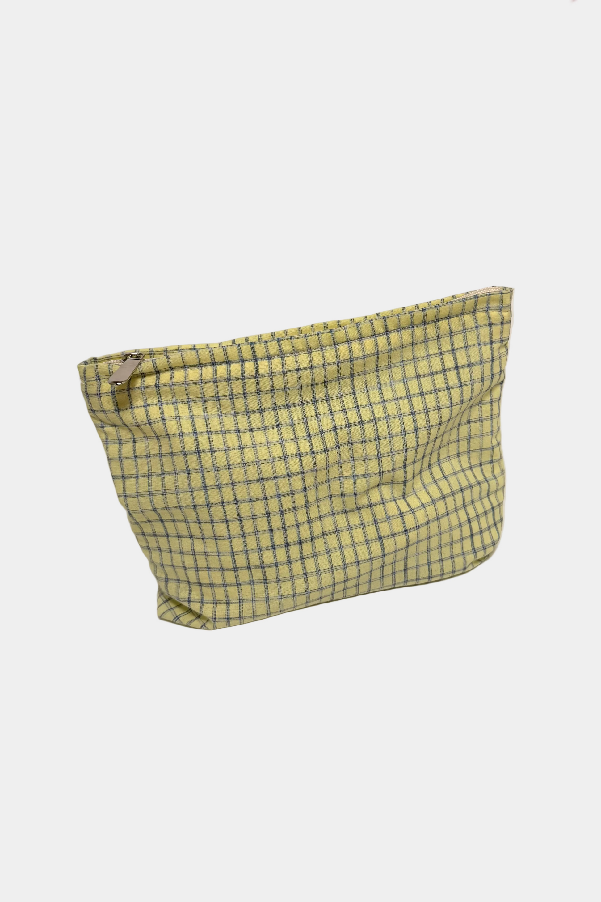 Yellow checkered pouch on a white surface 