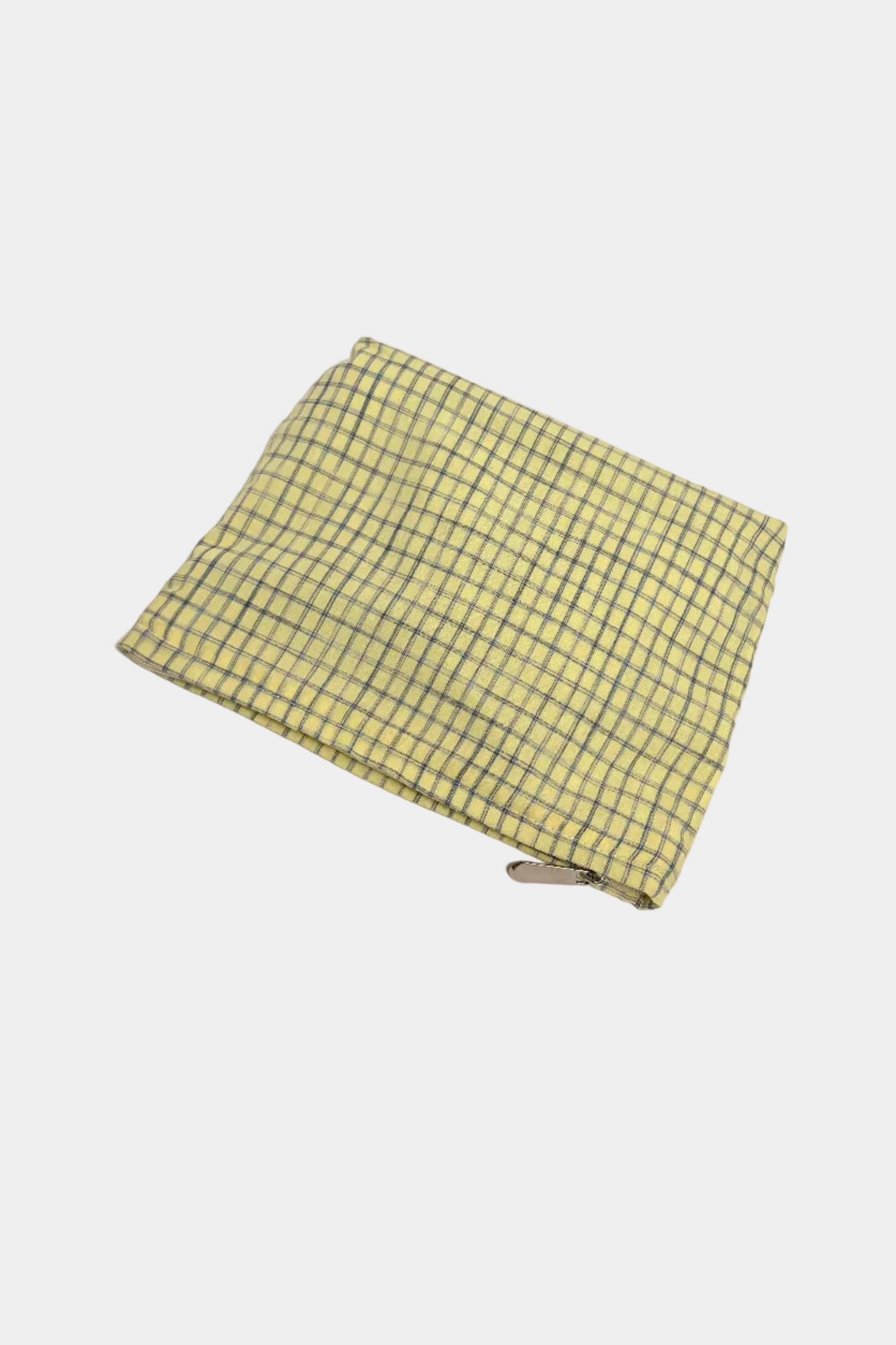 Yellow checkered pouch on a white surface 