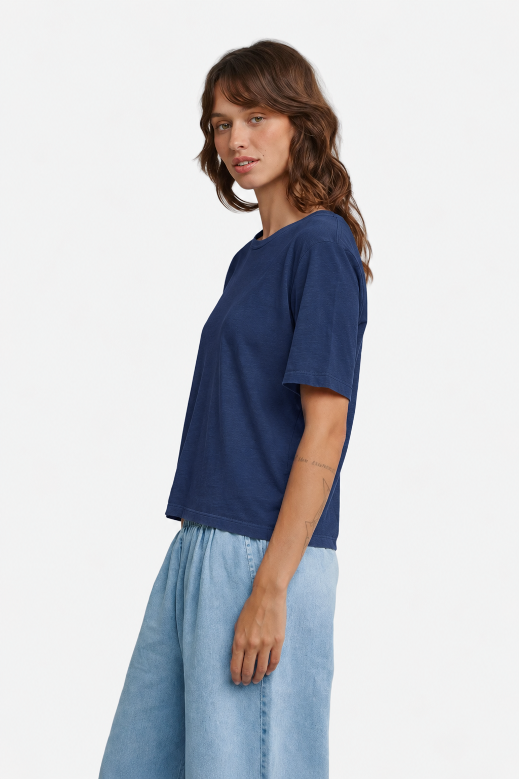 A model wearing Jungmaven Silverlake tee in Deep Indigo, viewed from the side - East Coast General