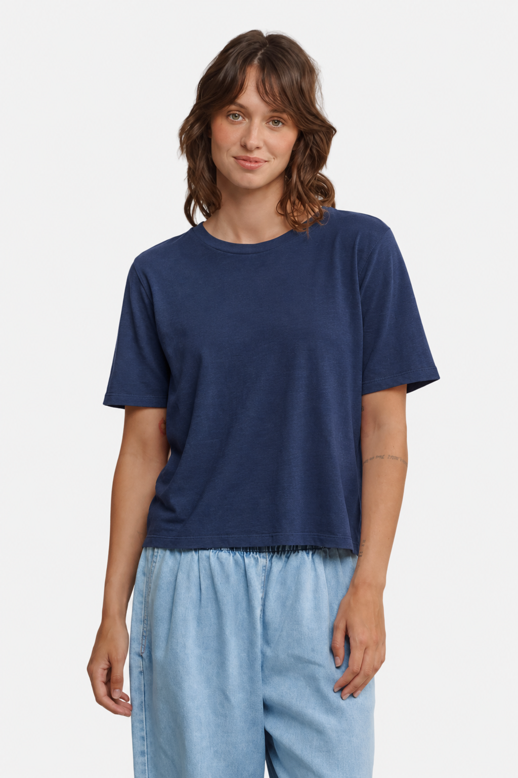 A person wearing the Jungmaven Silverlake tee in Deep Indigo - East Coast General