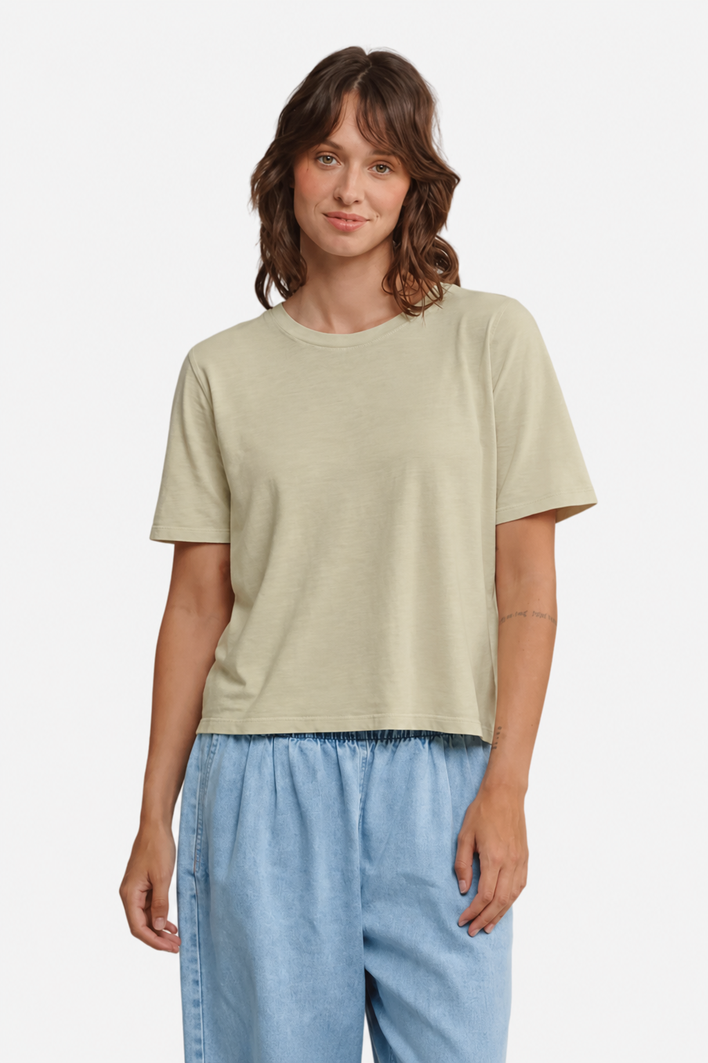 A model wearing the Jungmaven silverlake tee in Desert Khaki with pale blue denim pants - East Coast General 