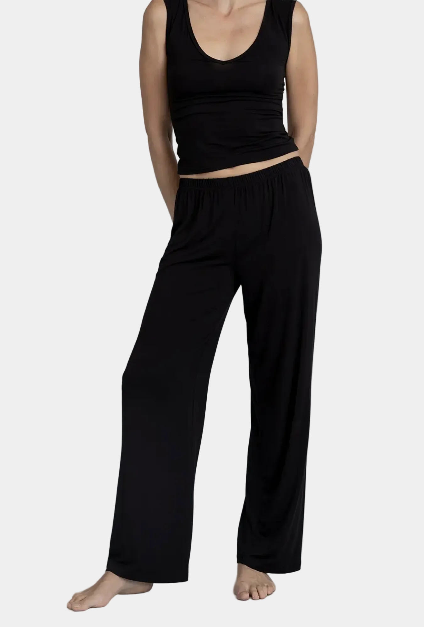Model wearing Kye intimates Recline Pant in Black fluid wide leg lounge pants front view