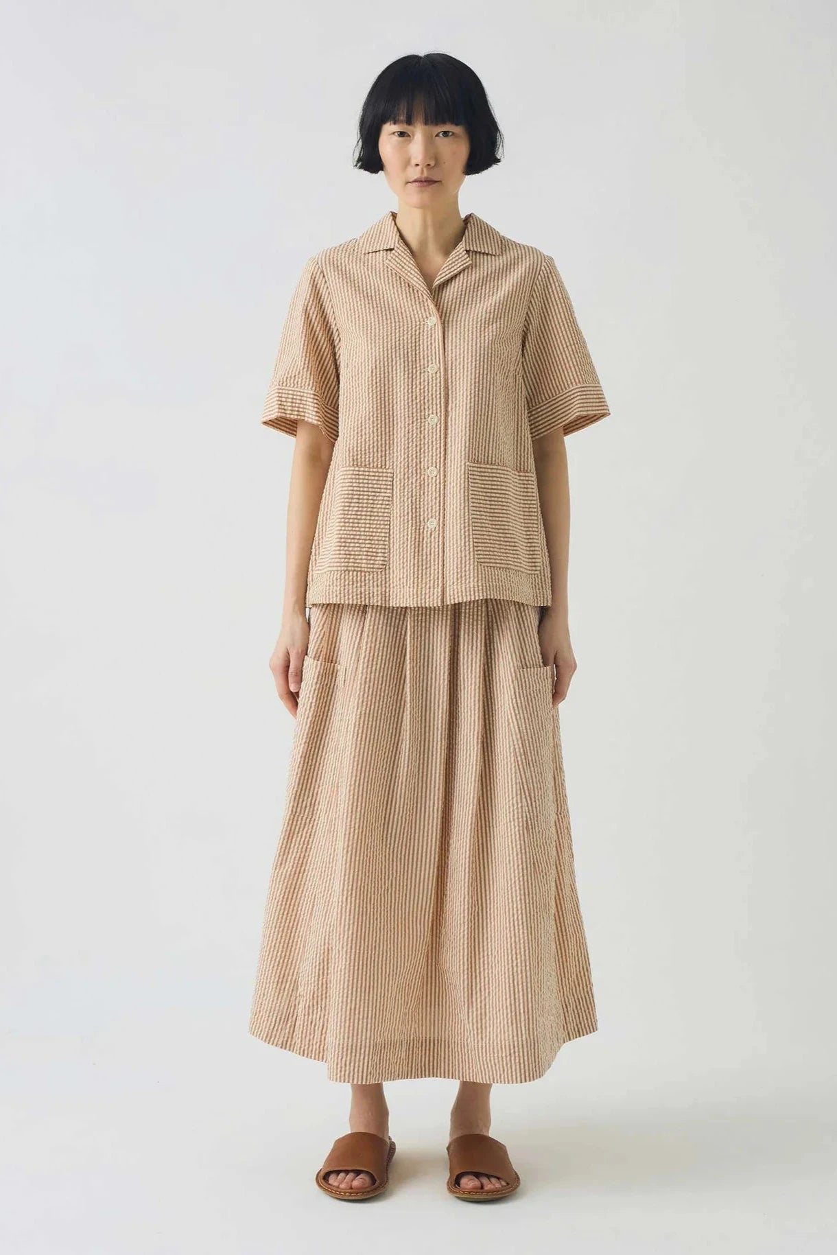 Beige stripe shirt on a light gray background