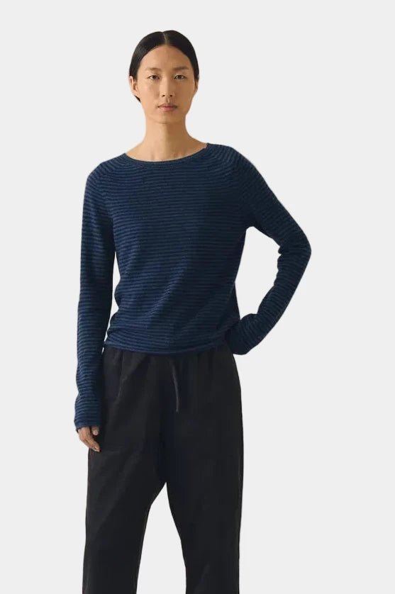 Front view of TOAST Denim Blue Stripe Wool Cashmere Sweater styled with relaxed black drawstring trousers