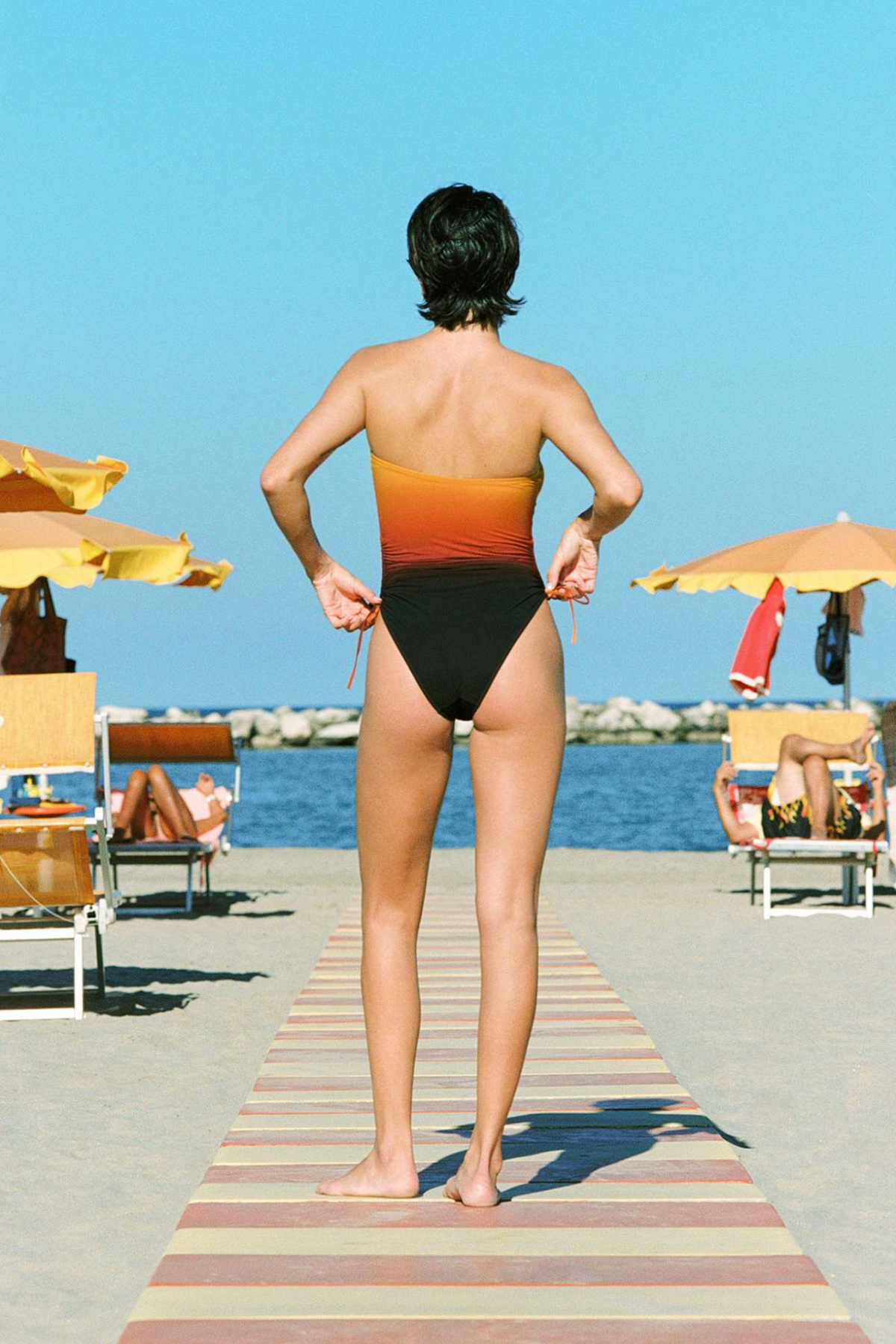 Rear view of a women wearing Lido Sessantadue one piece in Negroni - East Coast General