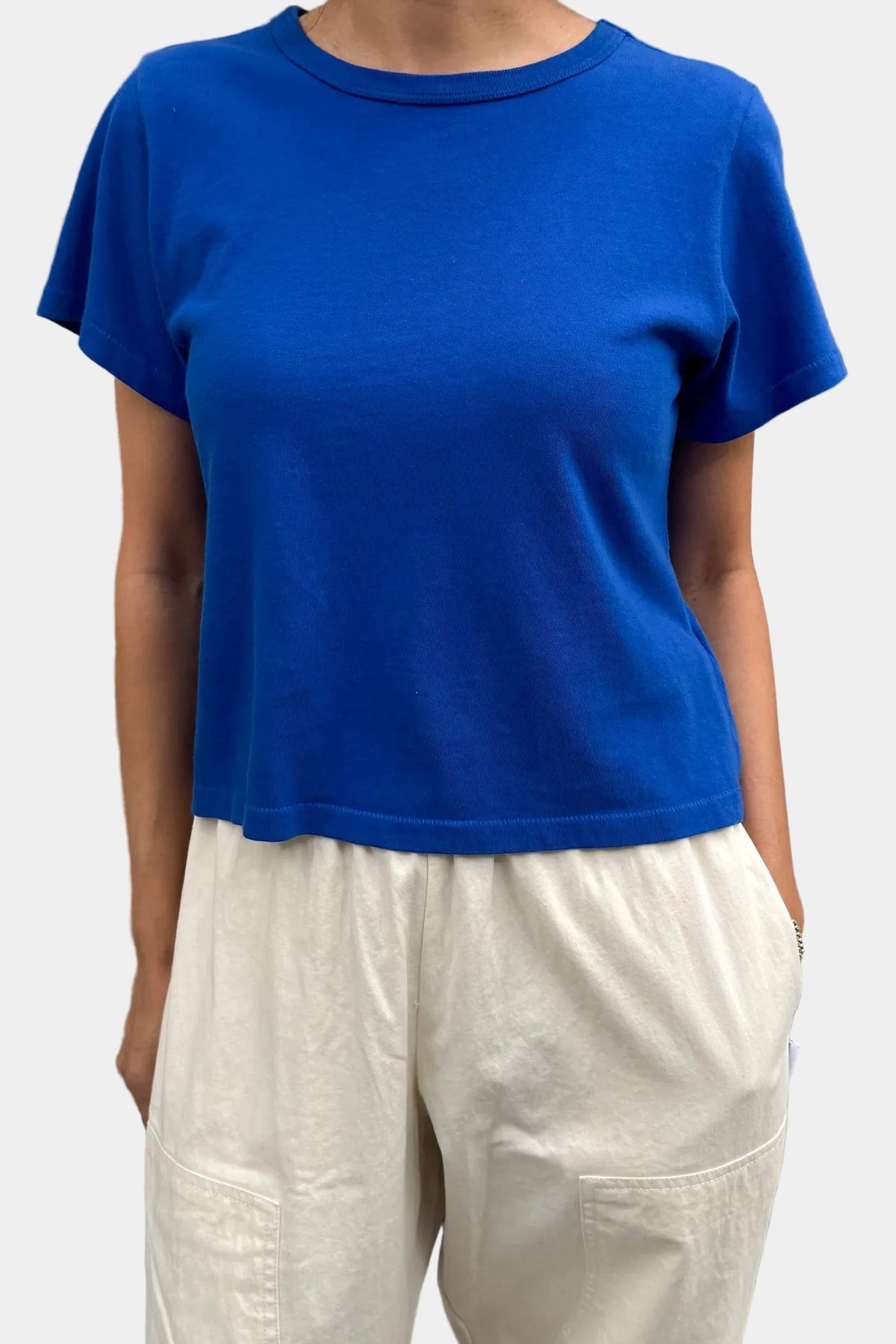 Front view of model wearing Le Bon Shoppe Little Boy Tee in Cobalt blue showing cropped hem fit