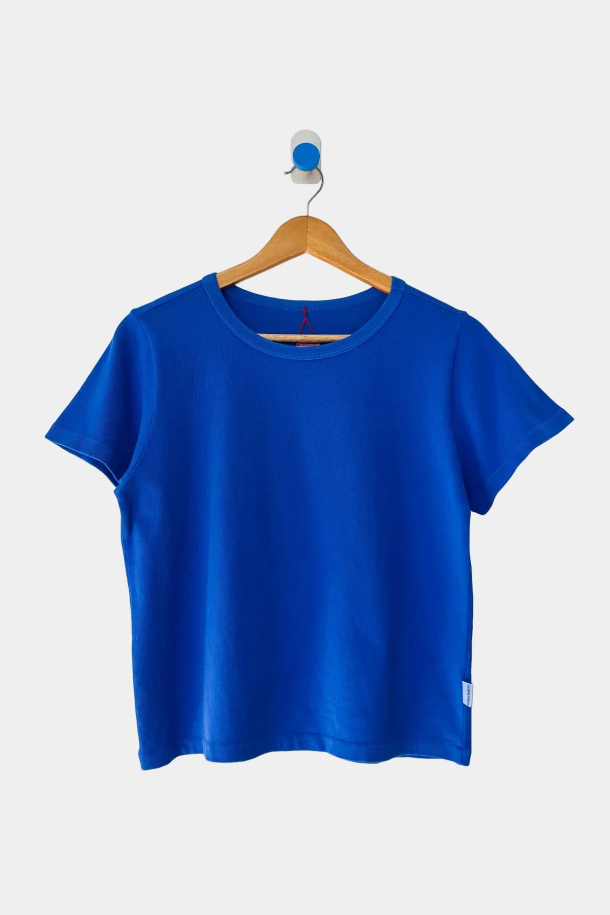 Le Bon Shoppe Little Boy Tee in Cobalt hanging on wooden coat hanger
