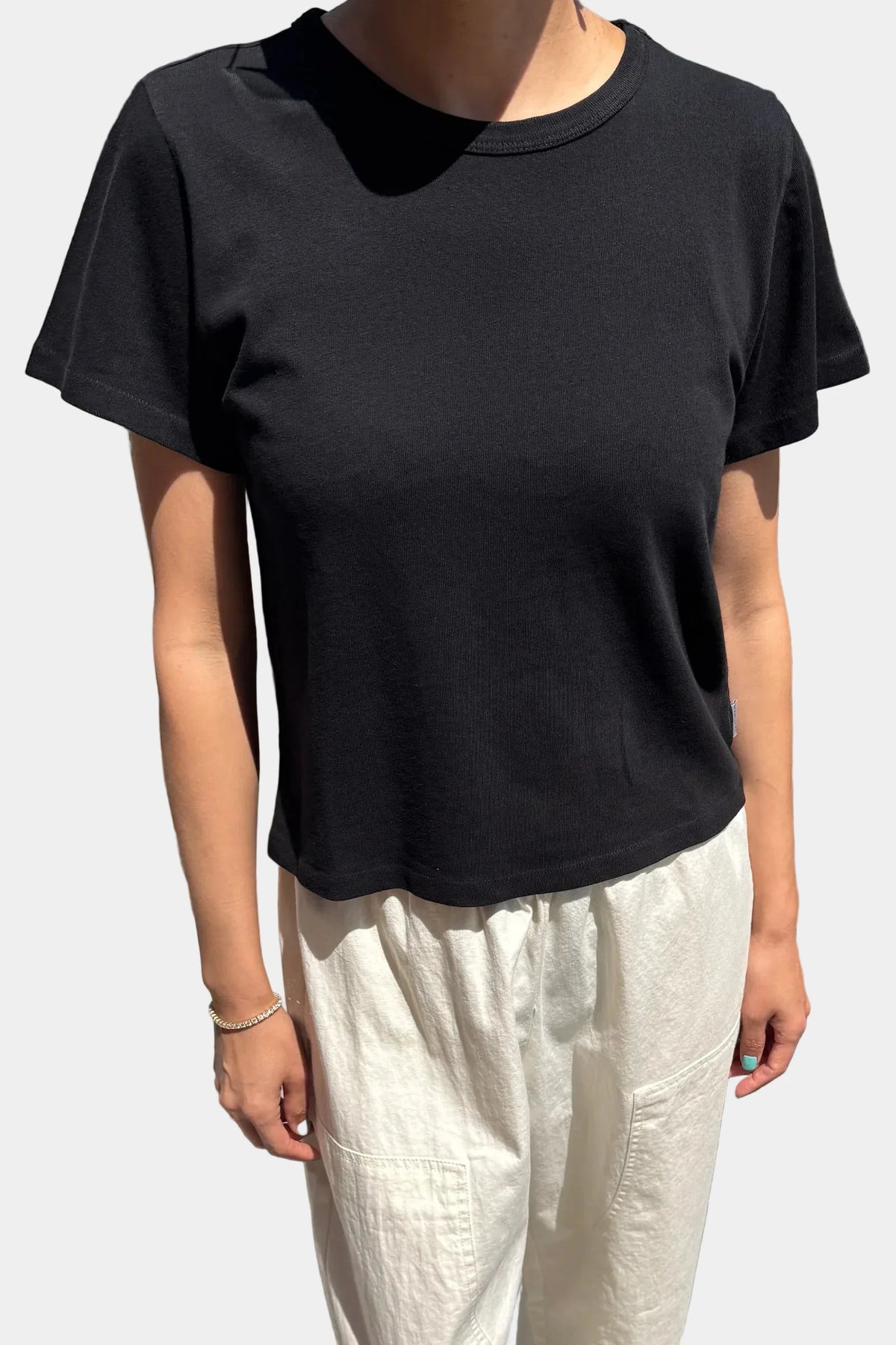 Front view of model wearing Le Bon Shoppe True Black Little Boy Tee showing waist length fit and baby rib neck
