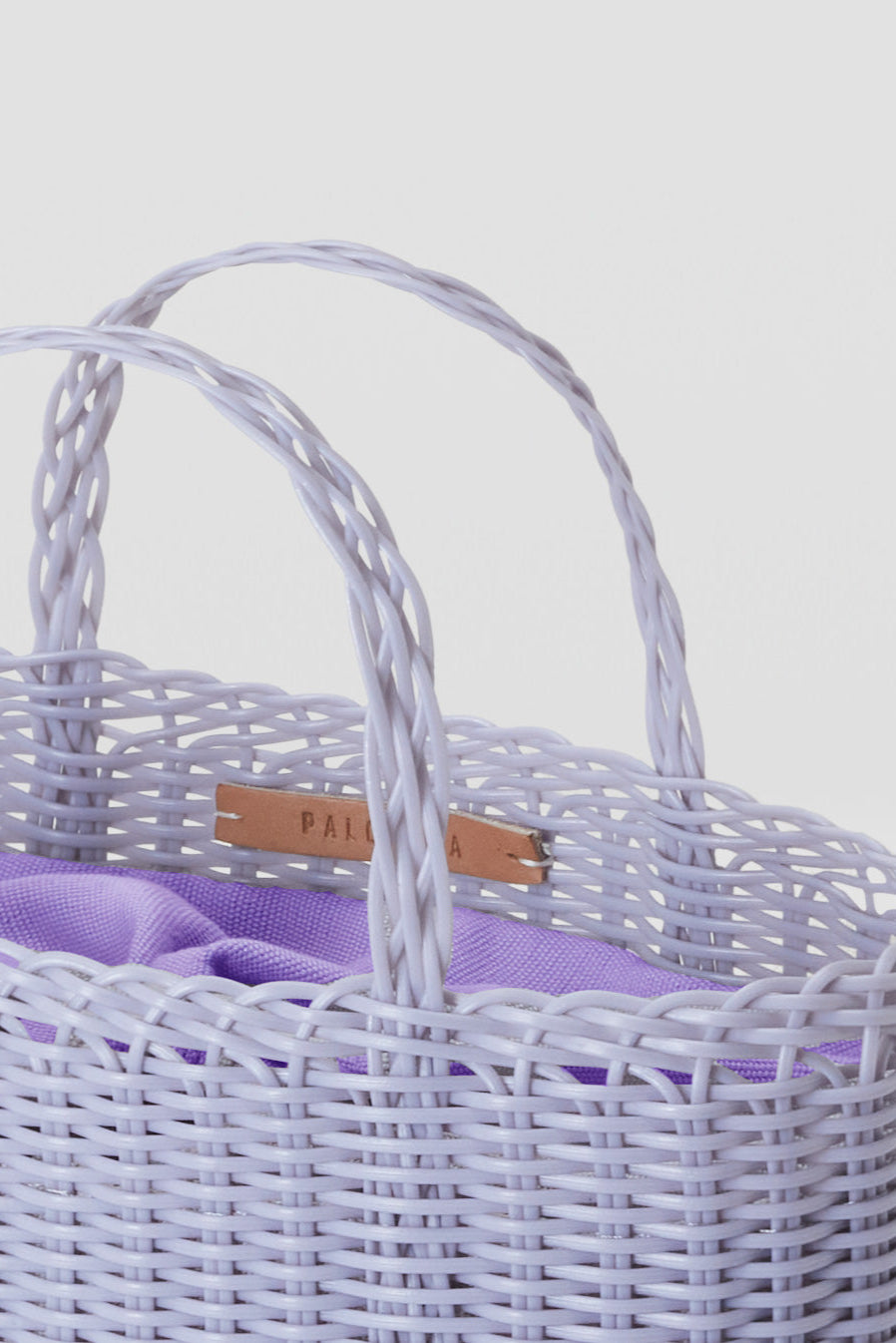 Woven handbag on a light gray background