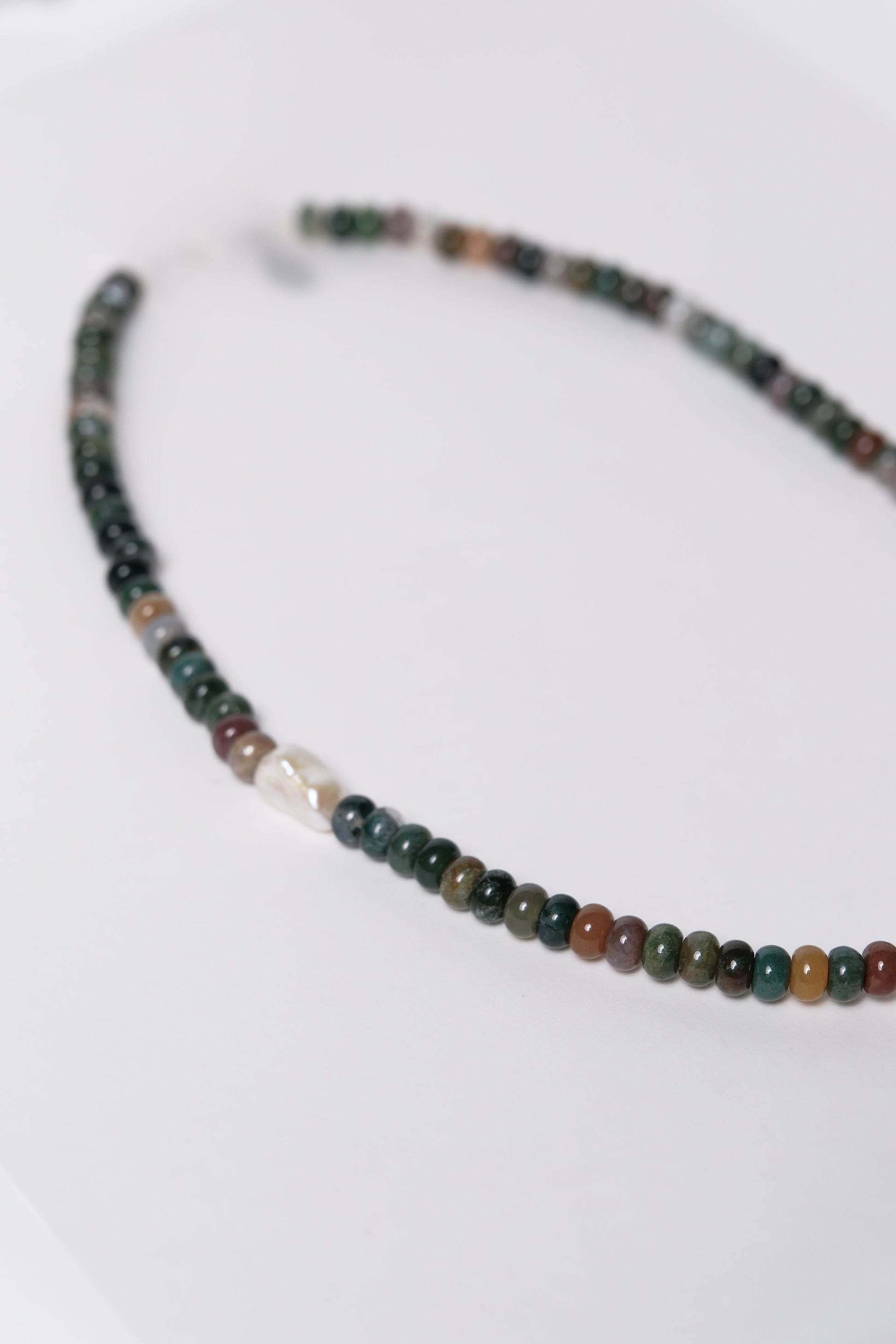Necklace with multicolored beads on a white background