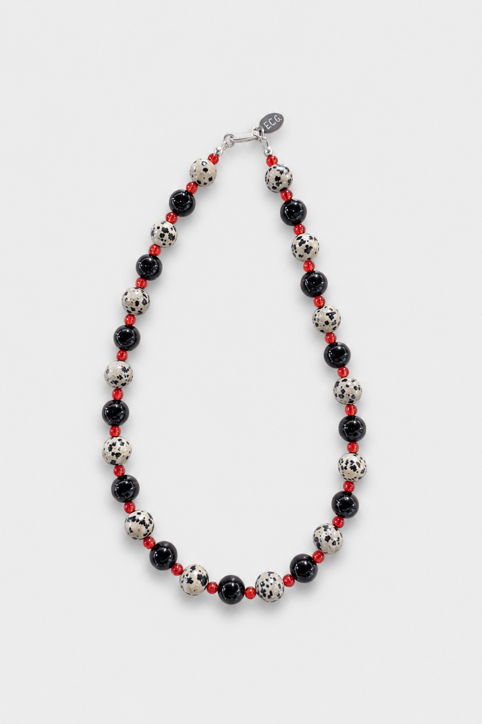 No. 4 Necklace featuring alternating black onyx beads, Dalmatian jasper beads, and small red spacer beads, finished with a silver clasp on a light gray background- East Coast General