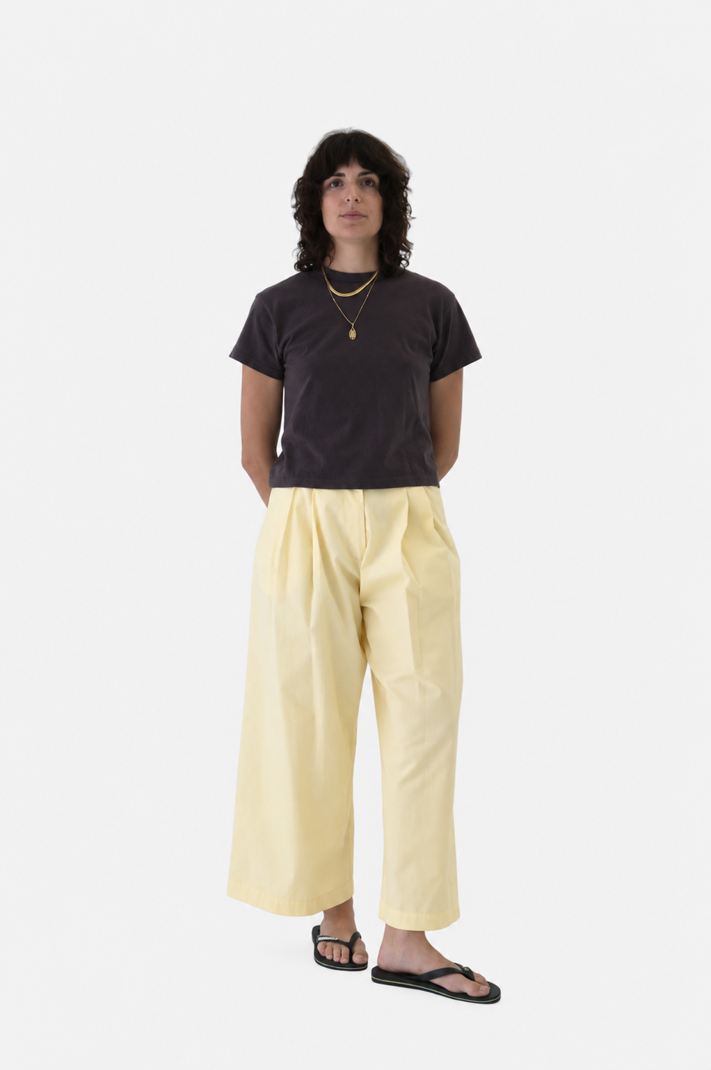 A  women wearing No. 53 pants in butter with Sunray hiaka tshirt in raisin, viewed from the front - East Coast General