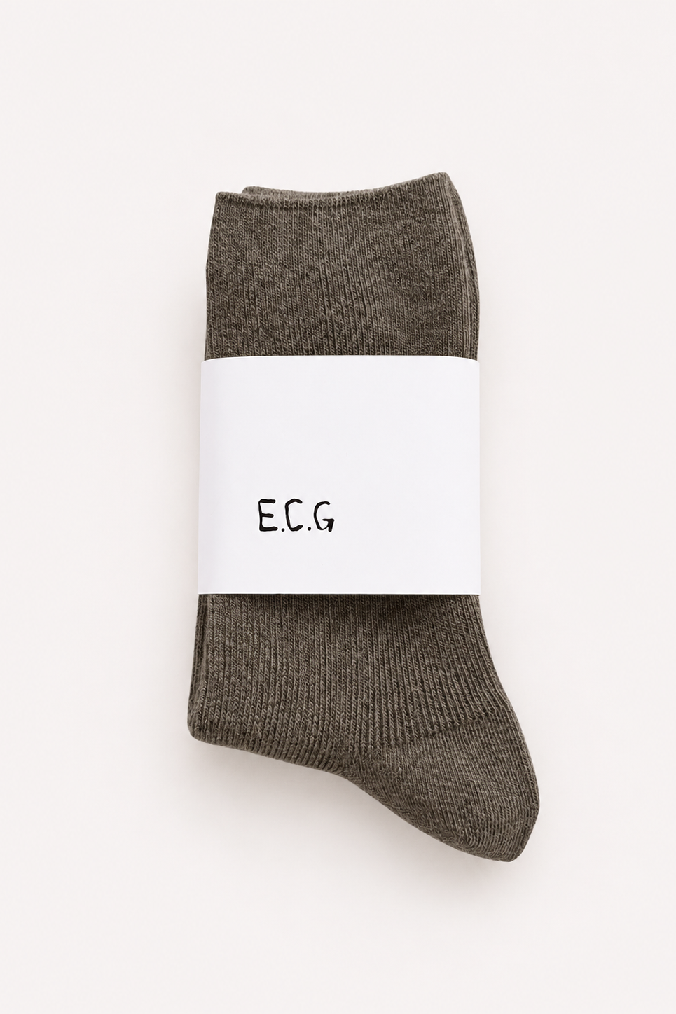 Green cotton ribbed socks with a white label displaying ECG branding on a white background - East Coast General