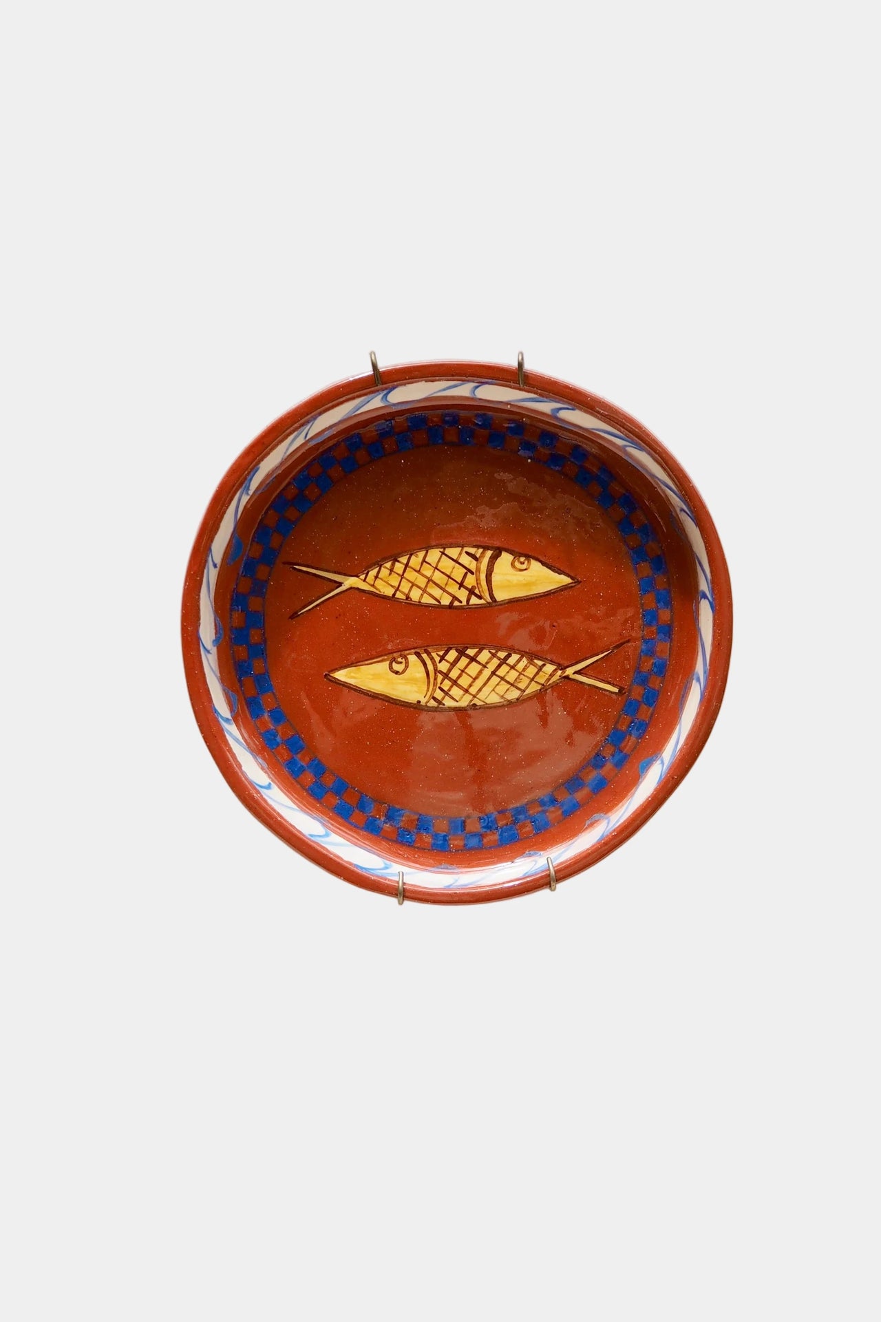 Ceramic plate with fish design on a white background