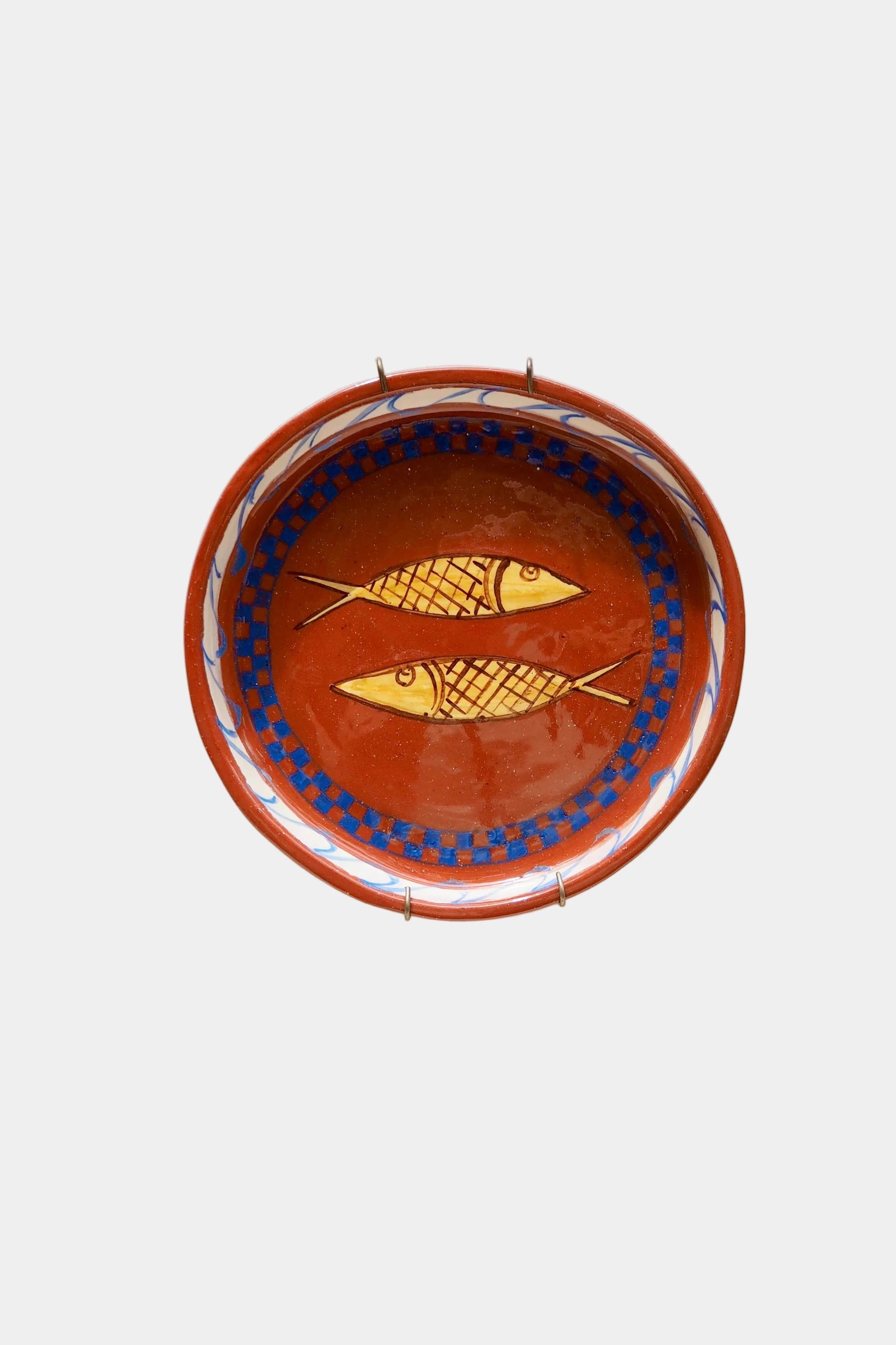 Ceramic plate with fish design on a white background