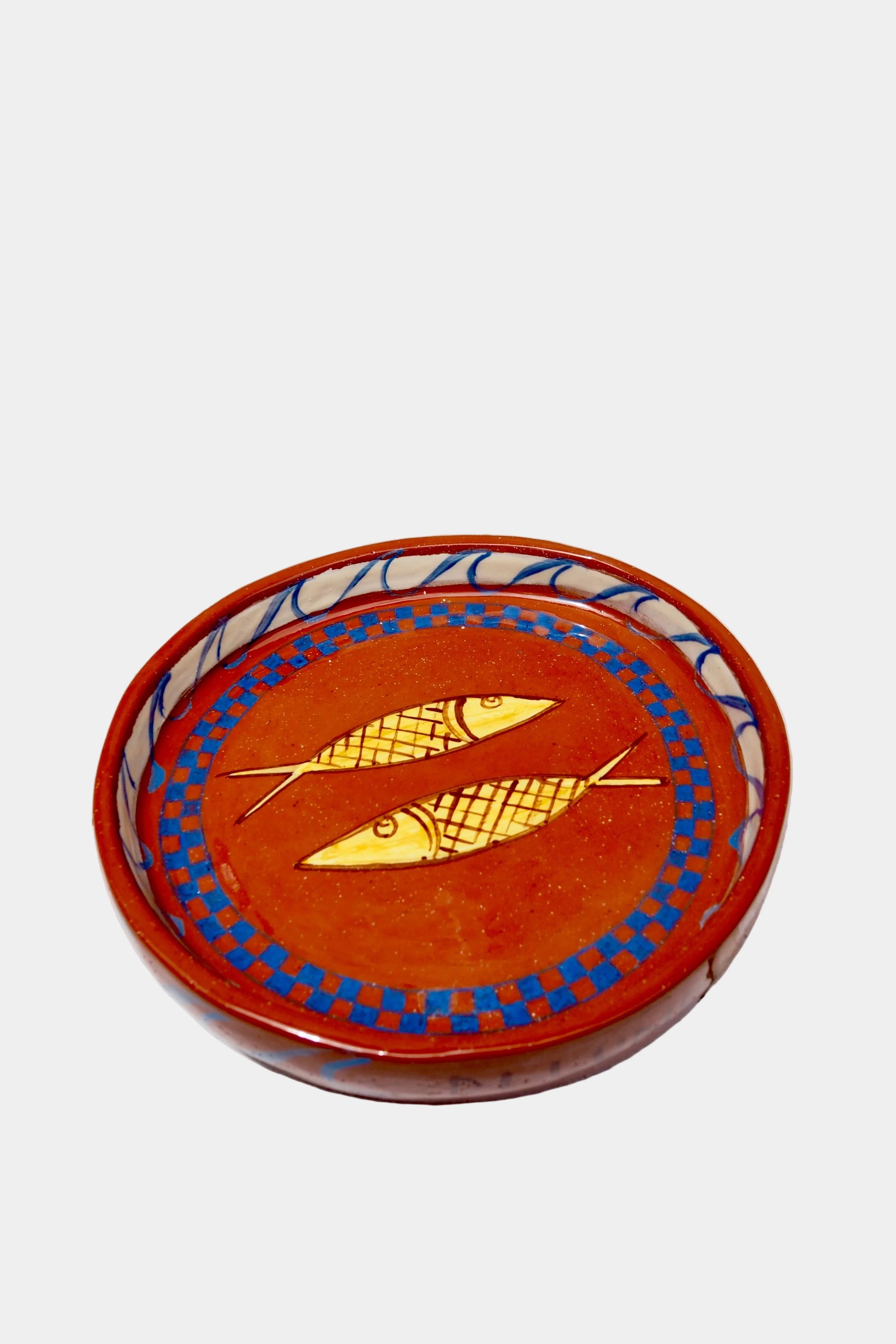 Decorative plate with fish design on a white background