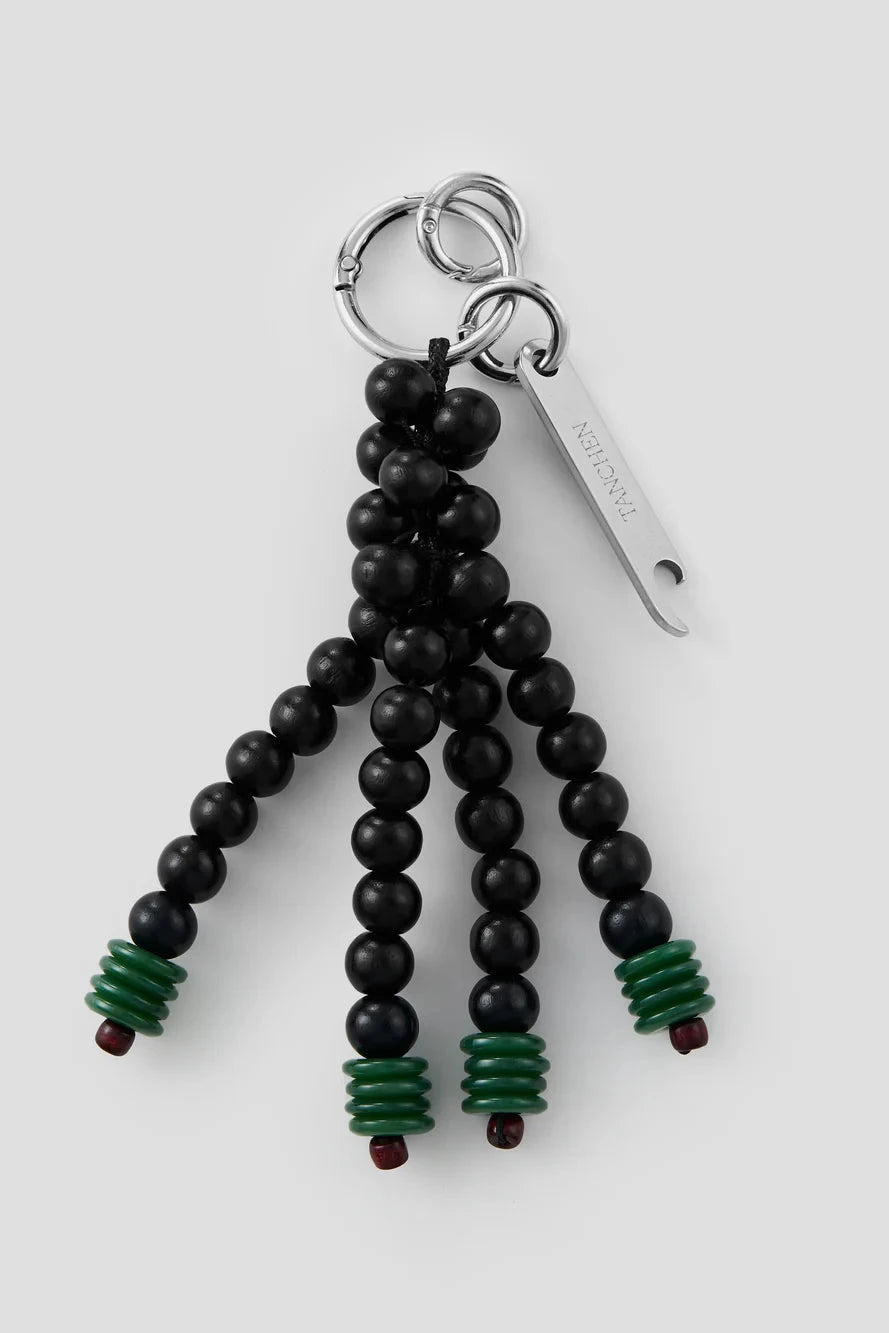 Black beaded keychain with green accents on a white background
