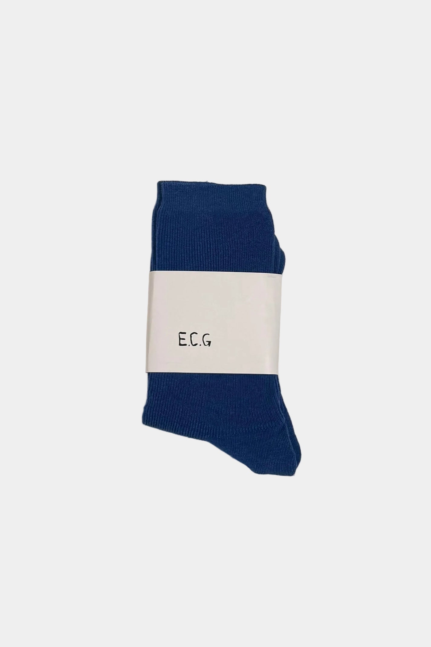 blue ribbed cotton sock against a light grey background