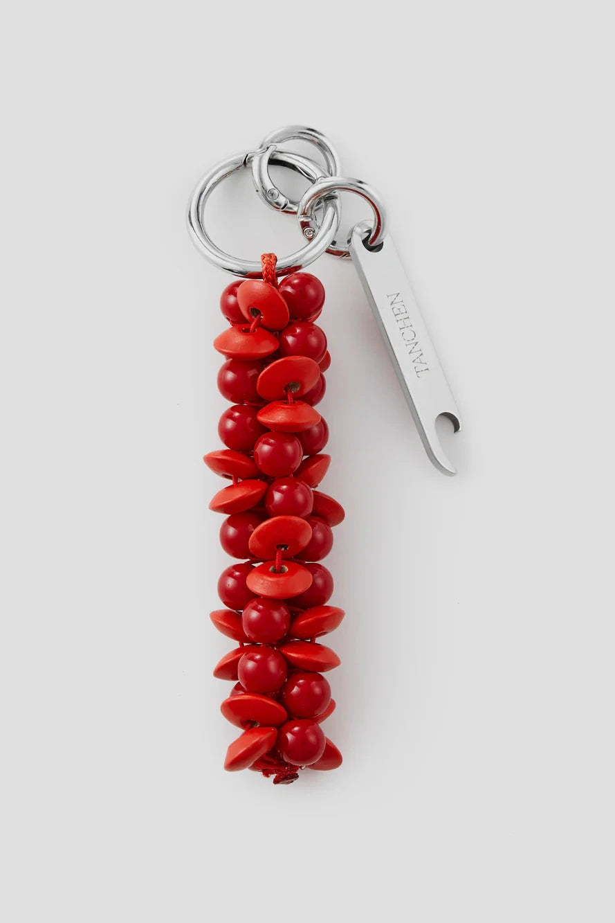 Red beaded keychain with a silver tag on a white background