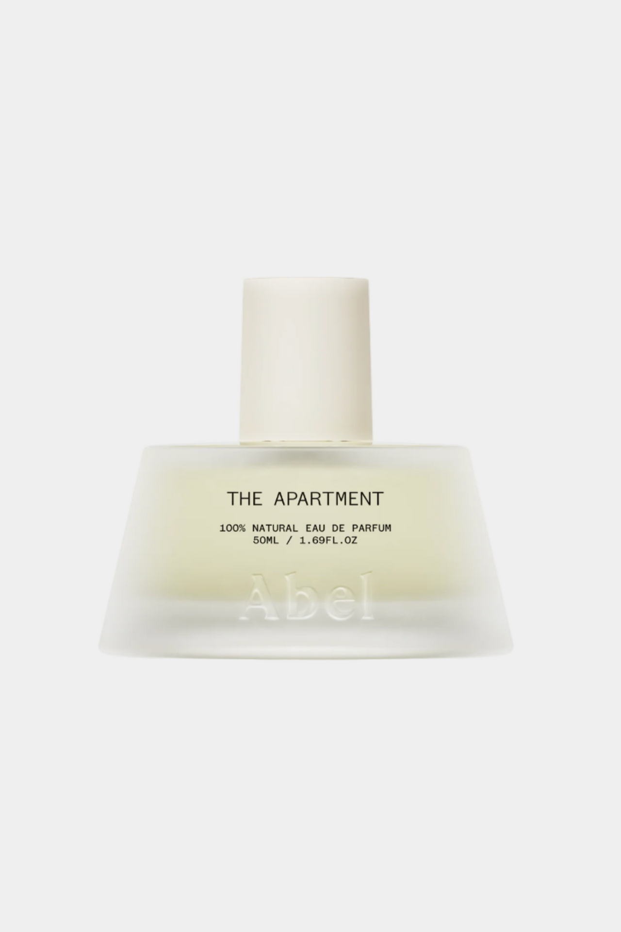 Perfume bottle labeled 'The Apartment' on a white background